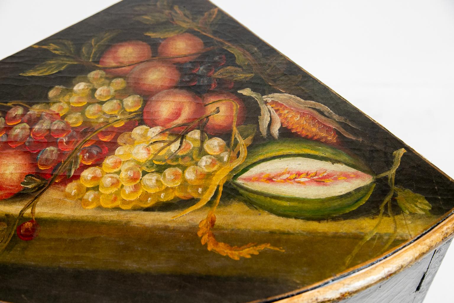 Bemalter englischer Eckschrank mit Bogenfront, auf dem ein Obststillleben gemalt ist. Auf der Vorderseite ist eine spielende Katze mit Kätzchen auf Kabelbeinen abgebildet.
  