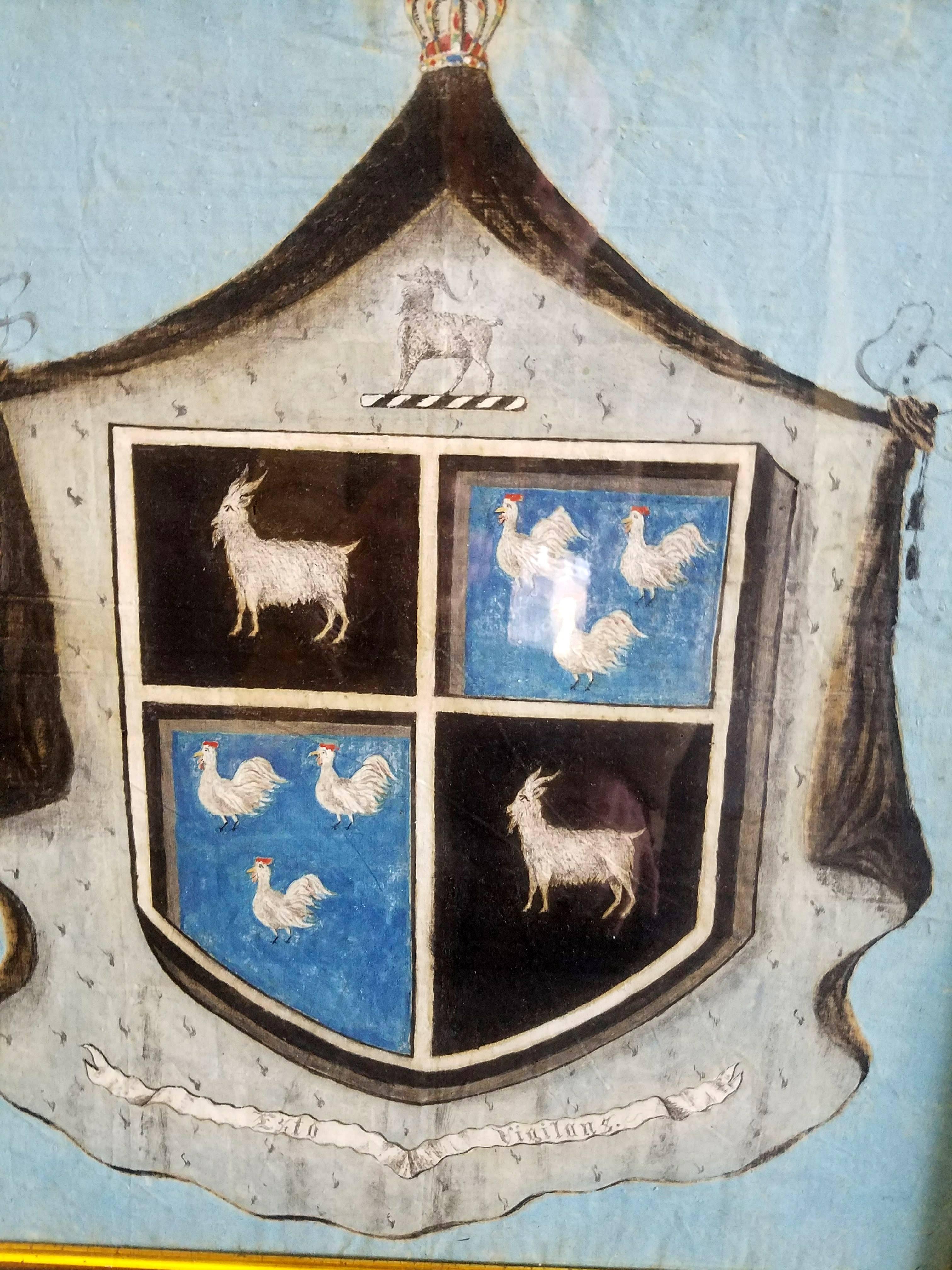 Painted Coat of Arms on Canvas, 
Motto- Esto Vigilans.
18th century
Possibly Spanish.

The unusual coat of arms is painted on canvas. The arms depict a statant goat argent quartering three chickens or cockerels argent. The motto Esto Vigilans