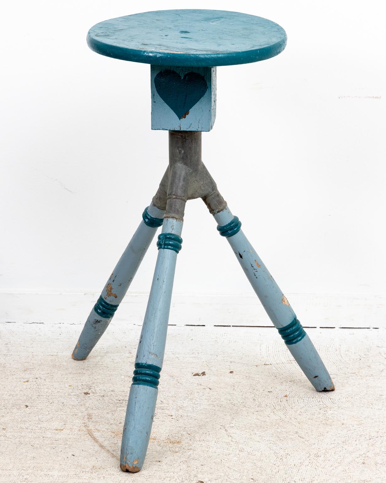 Blue painted folk art side table on tripod base with card suit motifs. The tripod base features a metal attachment to the stem that supports the round top. The piece is painted in tones of blue with King, Queen, Jack, and Ace symbols on the block