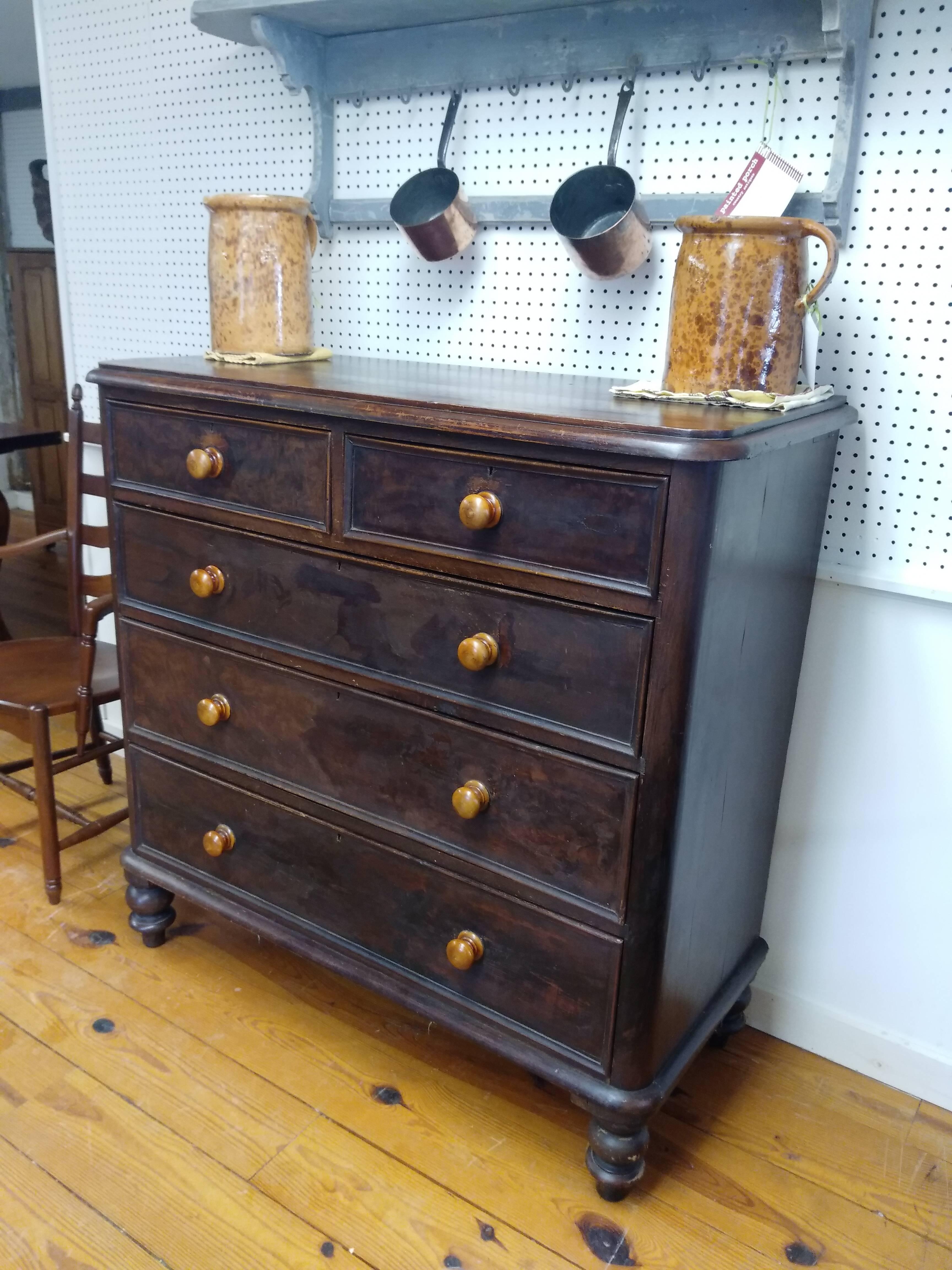 This is a very pretty painted wooden French chest of drawers with contrasting coffee-hued knobs. This piece dates from 1870 and is in very nice condition. It's rich looking and would be a most useful piece in any bedroom in your home. The top has a