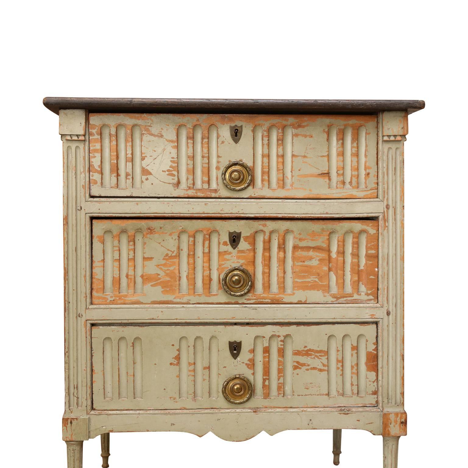 Painted French commode from France. Late 19th century, with three fluted-front drawers and ebonized top. Can also function as a nightstand or end table. 

 