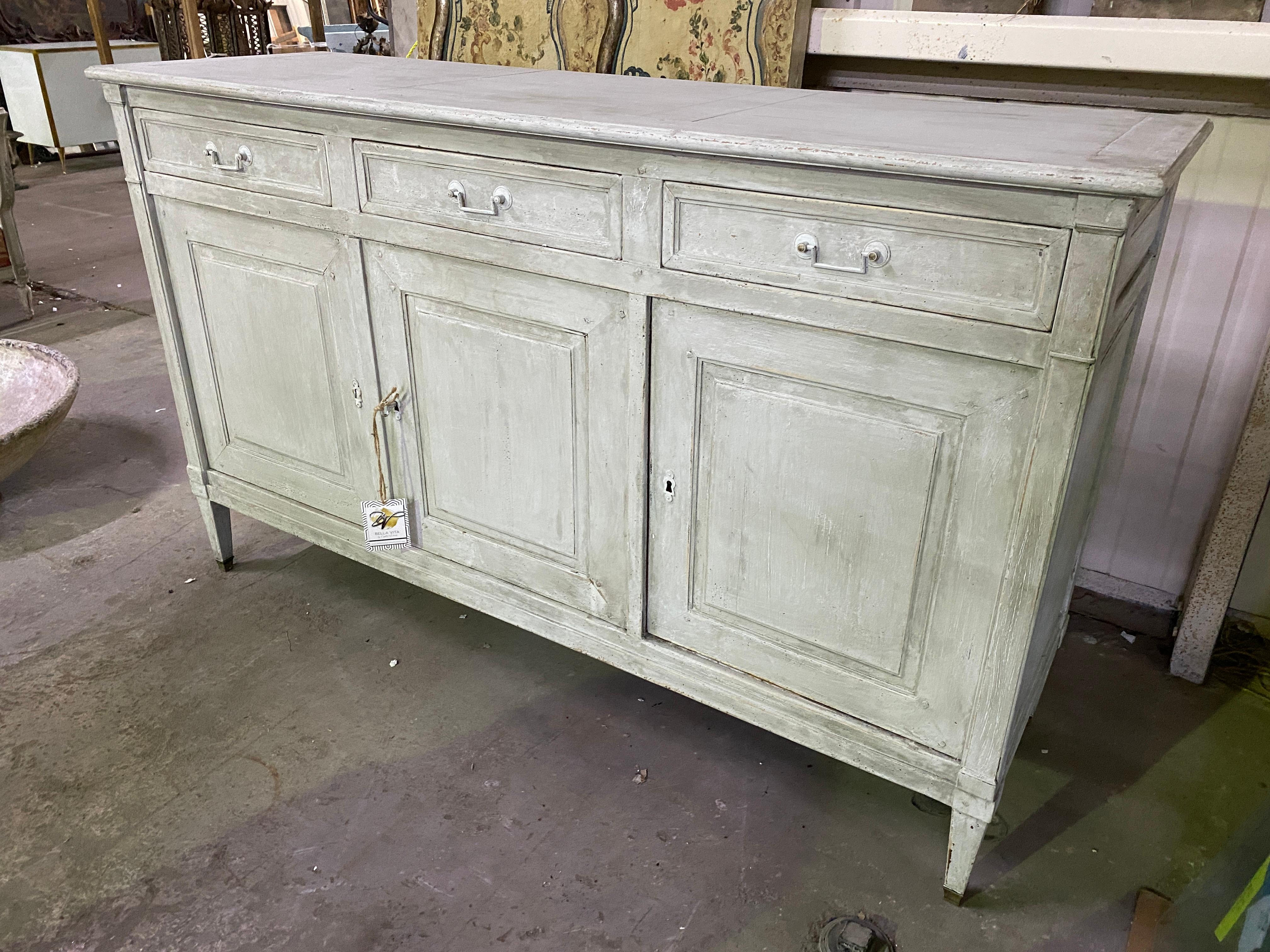 Beautiful imported credenza from France painted in a beautiful neutral tone. Perfect for any design space whether it be in a dining room, entry way or living room with a beautiful painting or mirror above it with decorative objects sitting atop.