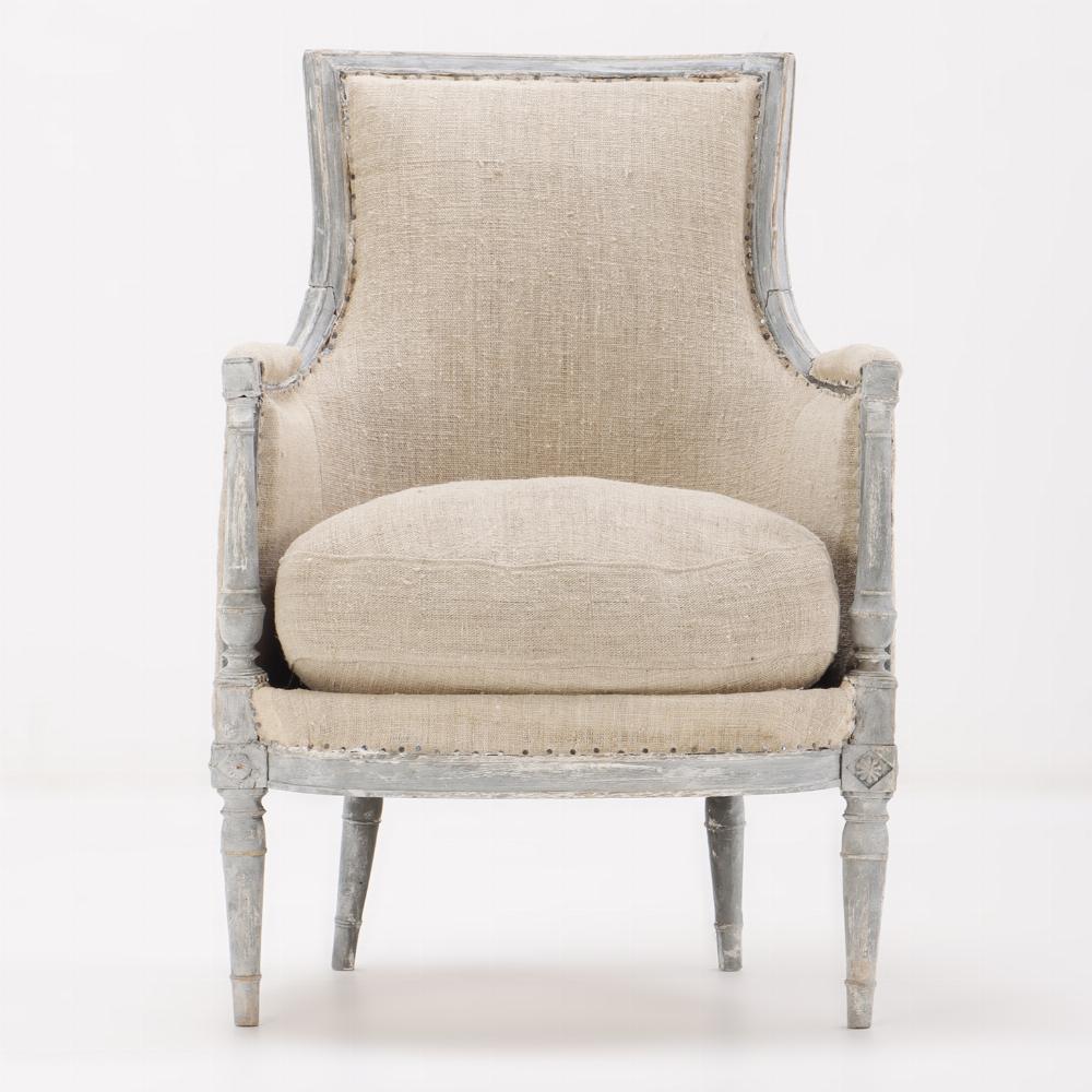 Painted French Directoire style bergere chair C 1900. This chair has just been reupholstered in a burlap type fabric.