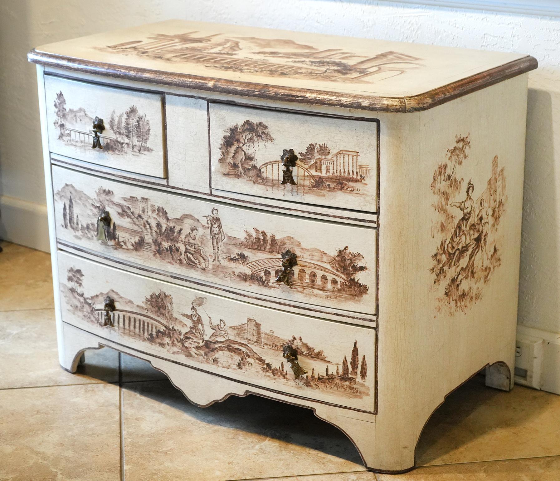 Of great shape with convex front and rounded corners this cream colored commode features hand painted landscapes with bridges, ruins, buildings and people on the top, the front and both sides. Bridges are the main theme in all the landscapes while