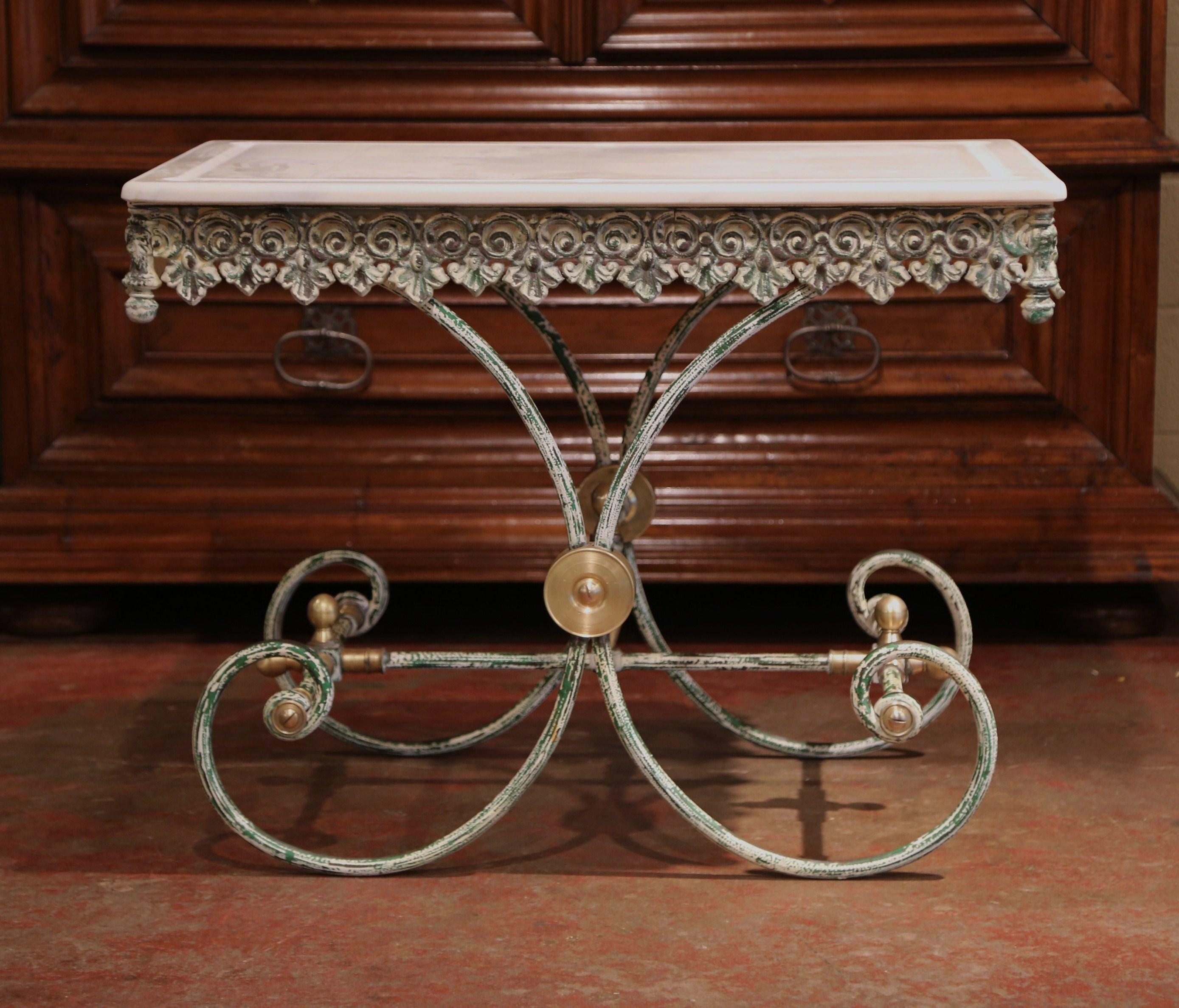 This French butcher table, or pastry table would add the ideal amount of surface space to any kitchen. Crafted in France, the iron work table has an antique green painted finished and features a scalloped apron with intricate metal work, beautiful
