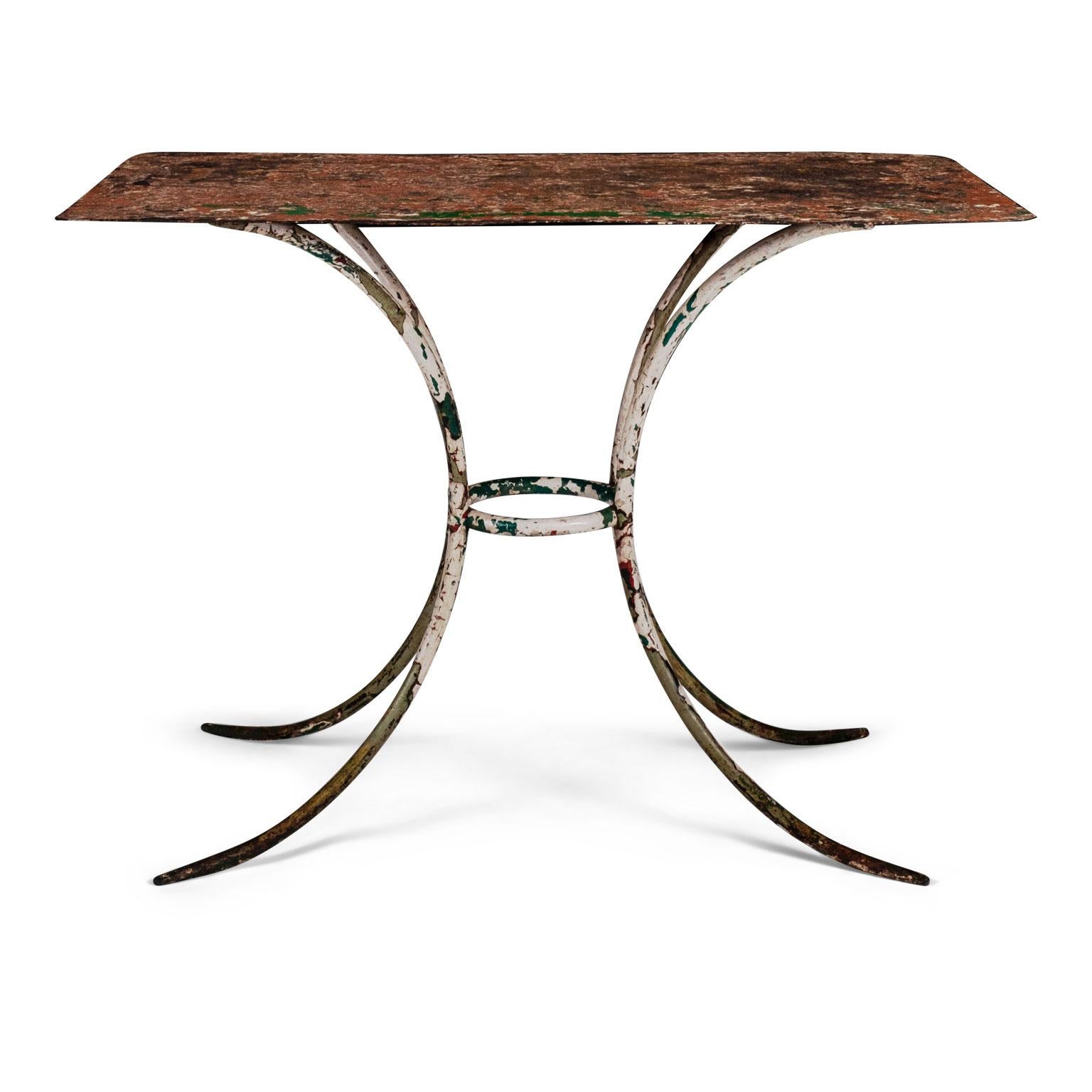 Painted iron garden table from France, circa 1930-1950. Rectangular steel top raised upon simple splayed legs. Covered in beautiful layers of rich white, green and terracotta color paint.