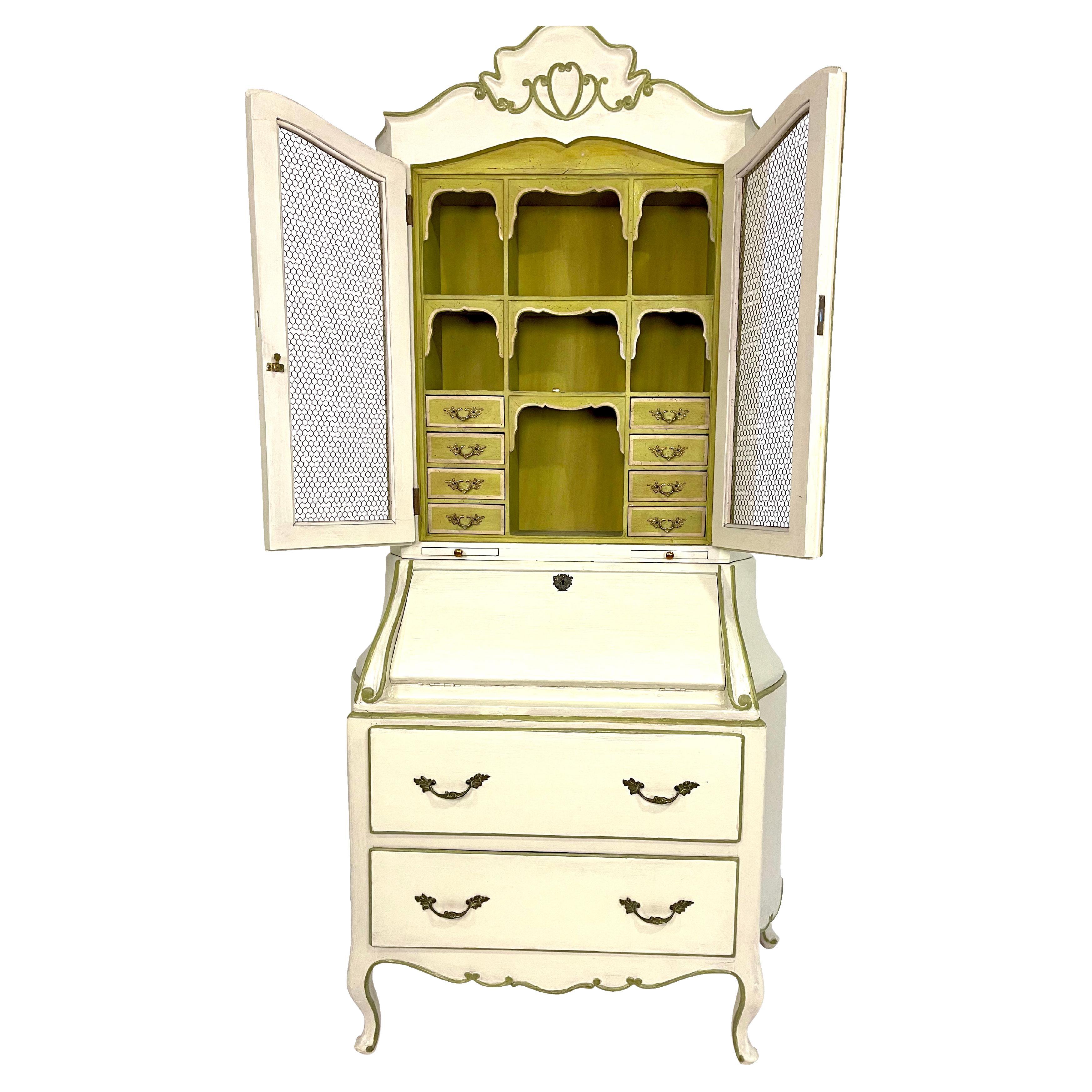 In an all-over ivory paint with a wonderful light green interior throughout this beautiful turn of the century, a French provincial secretary/desk came out of a New York City Park Avenue apartment. This lovely drop-front desk reveals four small