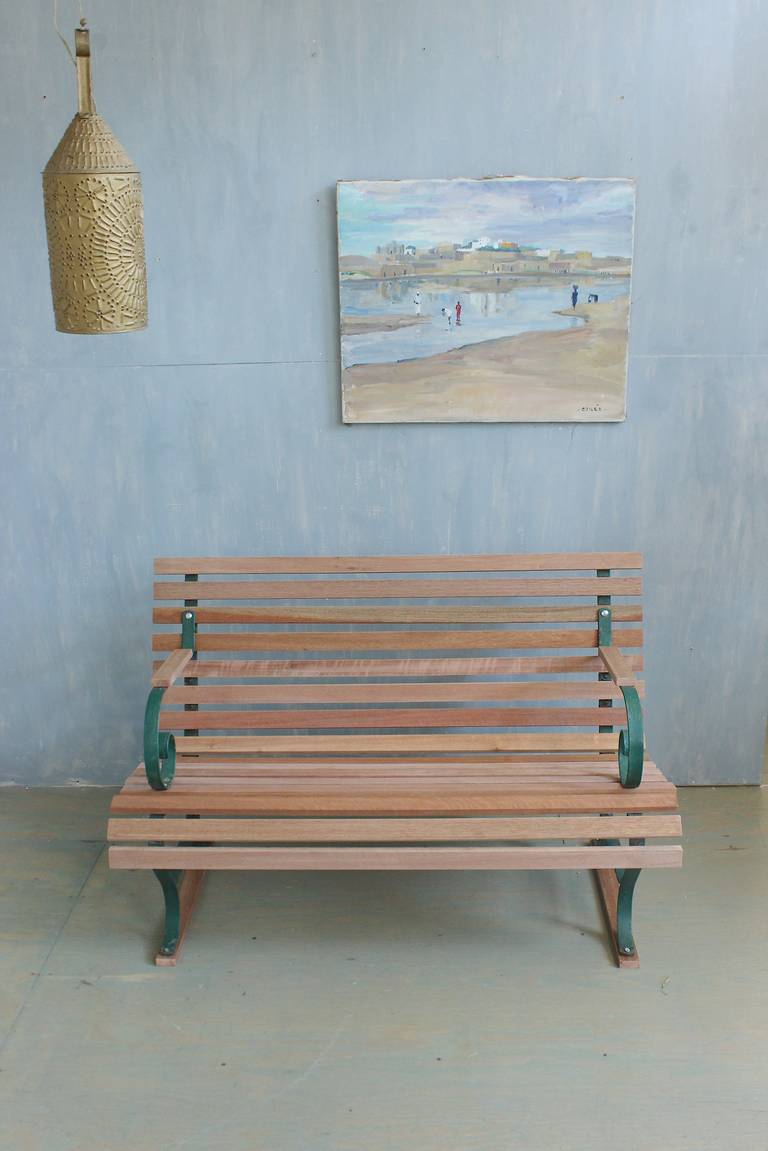 Restored 1920's American garden bench. The wood slates were recently replaced and are made in untreated mahogany, which will age nicely once the bench is placed outside.  The bench is in very good condition.  Pickups are  in our warehouse in