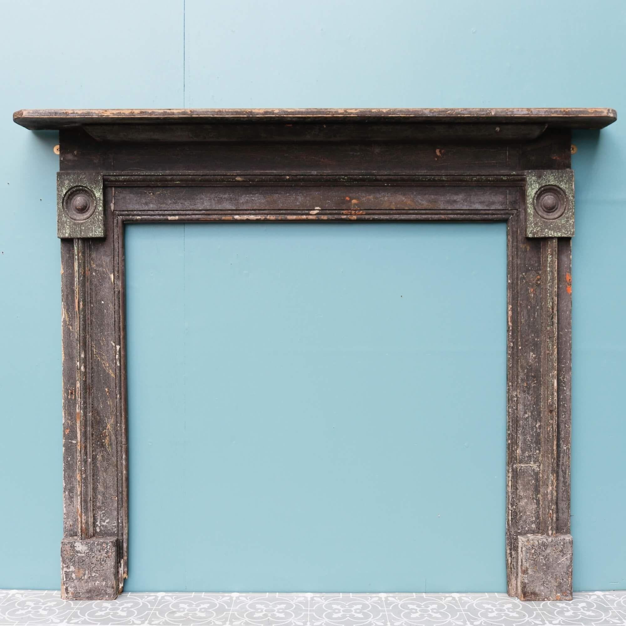Salvaged from a Norfolk farmhouse, this original 18th century bullseye fireplace is a timepiece from history. It is made in pine with several layers of old paint which has worn beautifully throughout the decades to give a wonderfully distressed