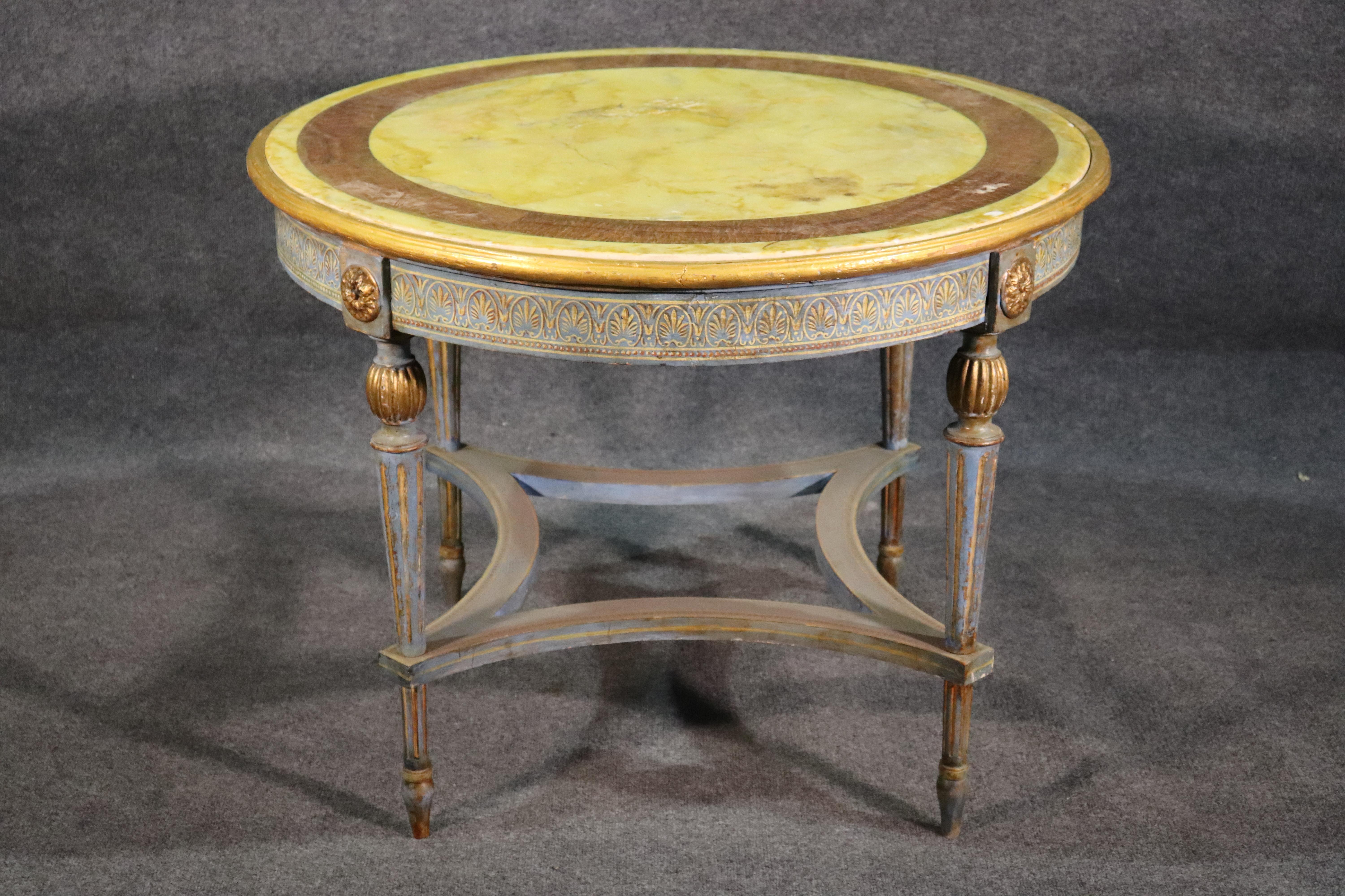 This is a rare Russian table with a beautiful color combination of pale yellow and light blue-gray painted base with gold gilded details. Dates to the 1840s.