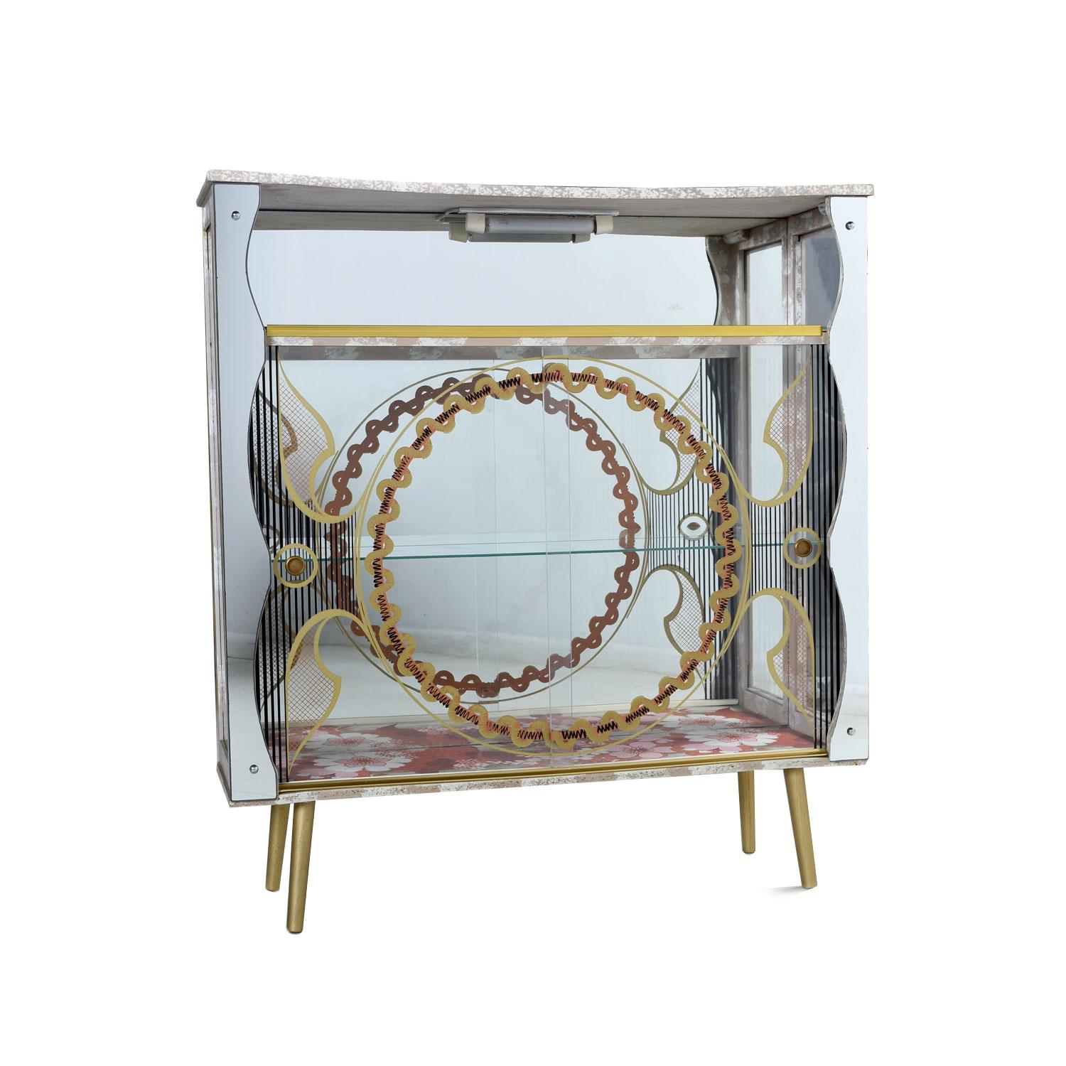 Rockabilly meets Art Deco with this funky, vintage 1950s, curio cabinet. This petite display case packs a bunch of personality into a small package. The built-in overhead lamp will dramatically illuminate your treasured collection. This china
