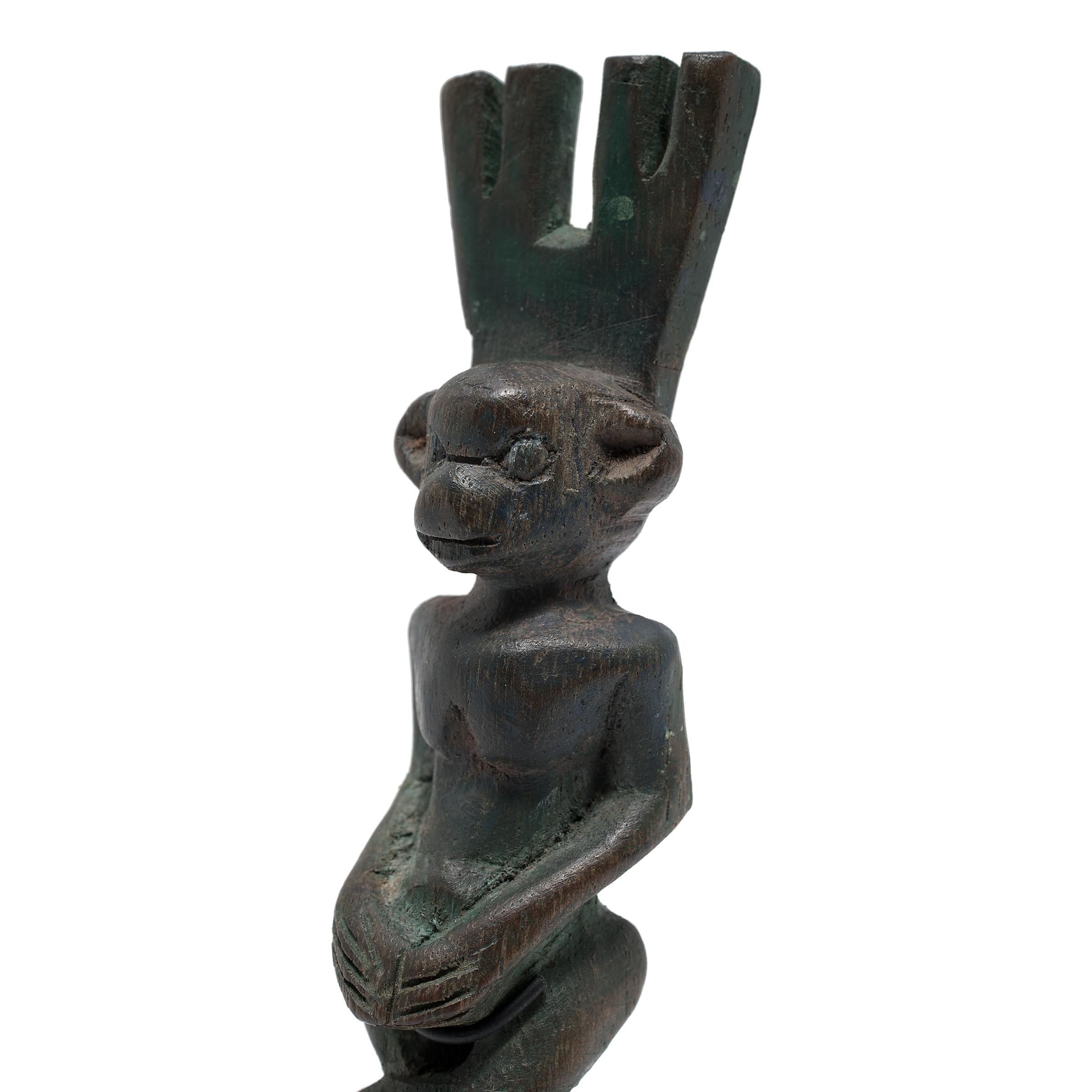 This petite wooden figure is actually a hand-carved slingshot created by a Maya artisan of Guatemala. Traditionally used to hunt small game, slingshot handles were carved of dense hardwoods into decorative forms such as animals, people, or mythical