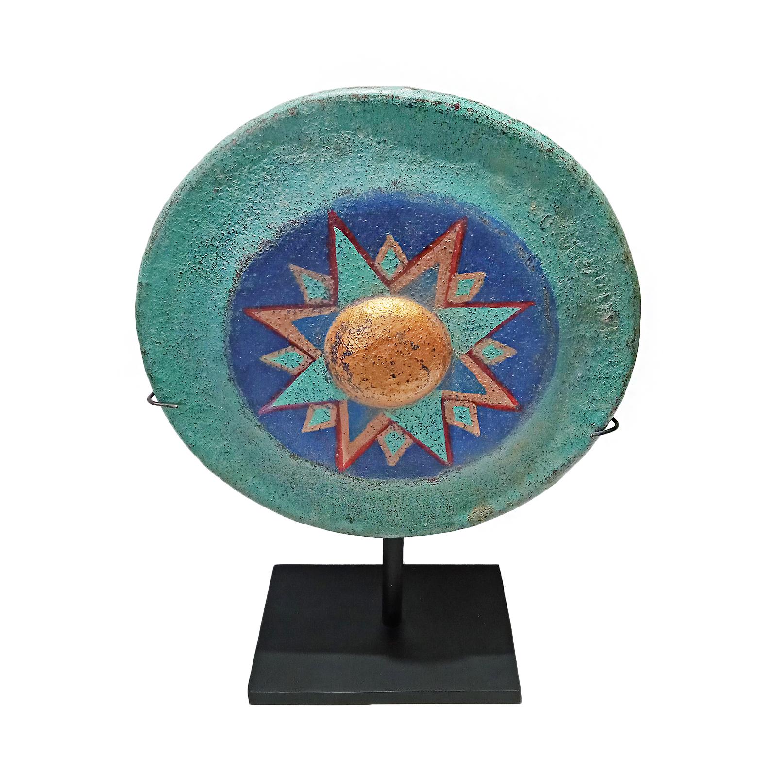 A vintage Indonesian gong, polychromed and repurposed for a freestanding sculpture. Mounted on a black metal stand. Circa 1940.  The front is painted in deep, well affixed colors simulating a star. The back has been left in its natural condition,