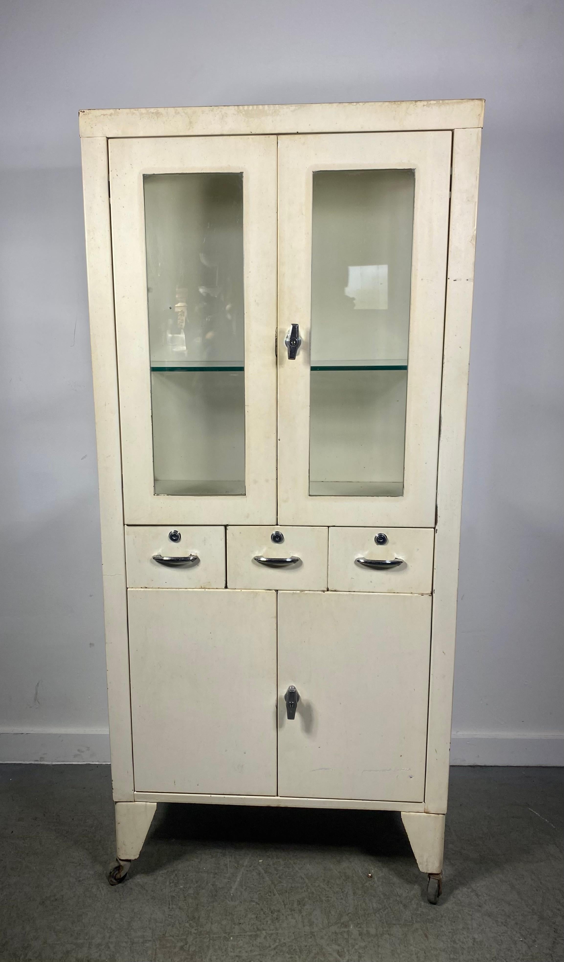 Handsome Painted Industrial Metal & glass Cabinet , c1950s...medical / architectural ,  Features upper cabinet / two doors , glass shelves. a top three drawers  over bottom storage,, (2 doors).Retains original factory paint / finish,,  Great for