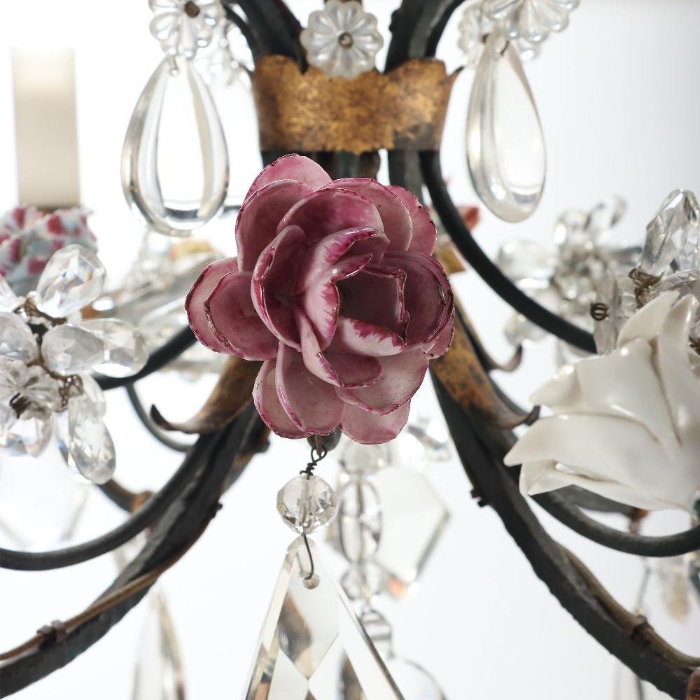 A 4 light painted iron and crystal chandelier with flowers decorations, 20th C.