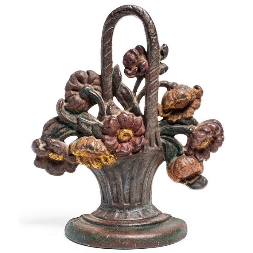 Charming cast iron doorstop with a cheerful flower basket design, made in England circa 1880. Sturdy and functional, the doorstop has a wonderful painted finish in a pastel palette.

