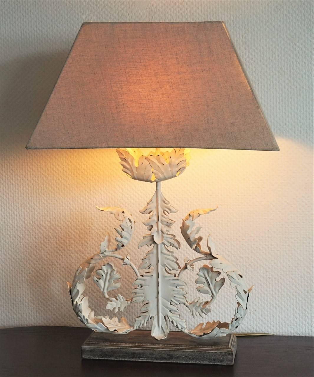 Large carved iron and painted foliage table lamp on wooden base, linen shade included, circa 1970.
One E27 light bulb holder
Height with shade 26 inches (66cm)
Width with shade 17.75 inches (45 cm)
Wooden base 11.75 inches wide, 3.75 inches deep