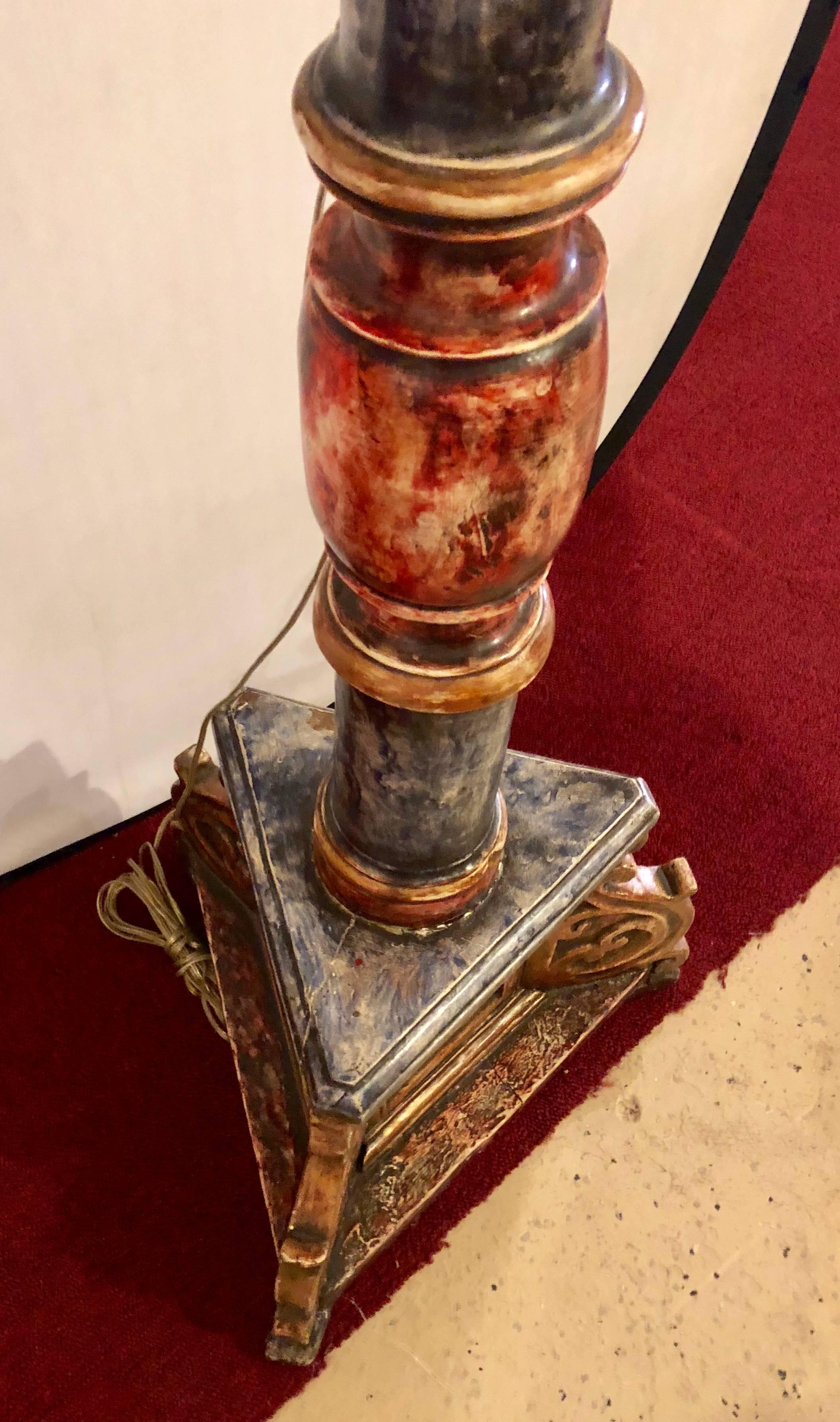 A painted Italian continental candle prick standing lamp 18th-19th century. Appears to be in its original paint form with a carved triangular base leading to a column form centre terminating in one sixty watt light bulb. In a marble finish having