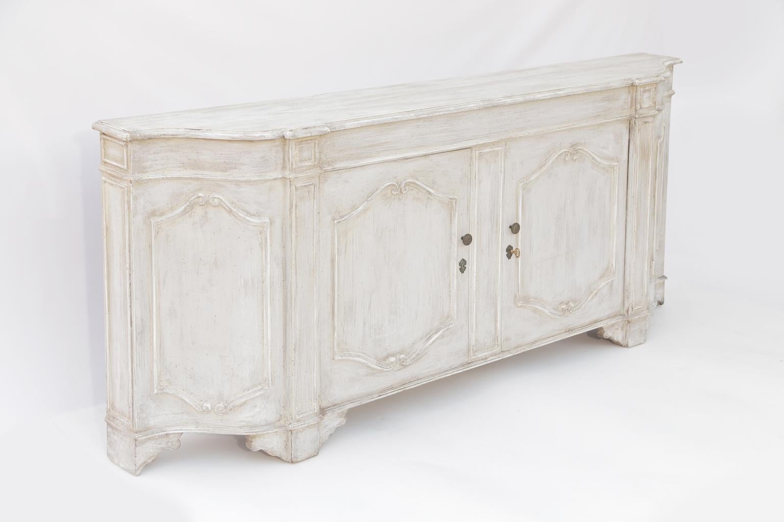Cabinet, having a very narrow profile of only 12 1/4 inches deep, its molded and shaped top on a conforming breakfront case, with double cupboard doors, all trimmed with scrolling moldings, raised on bracket feet. 

Stock ID: D2964.