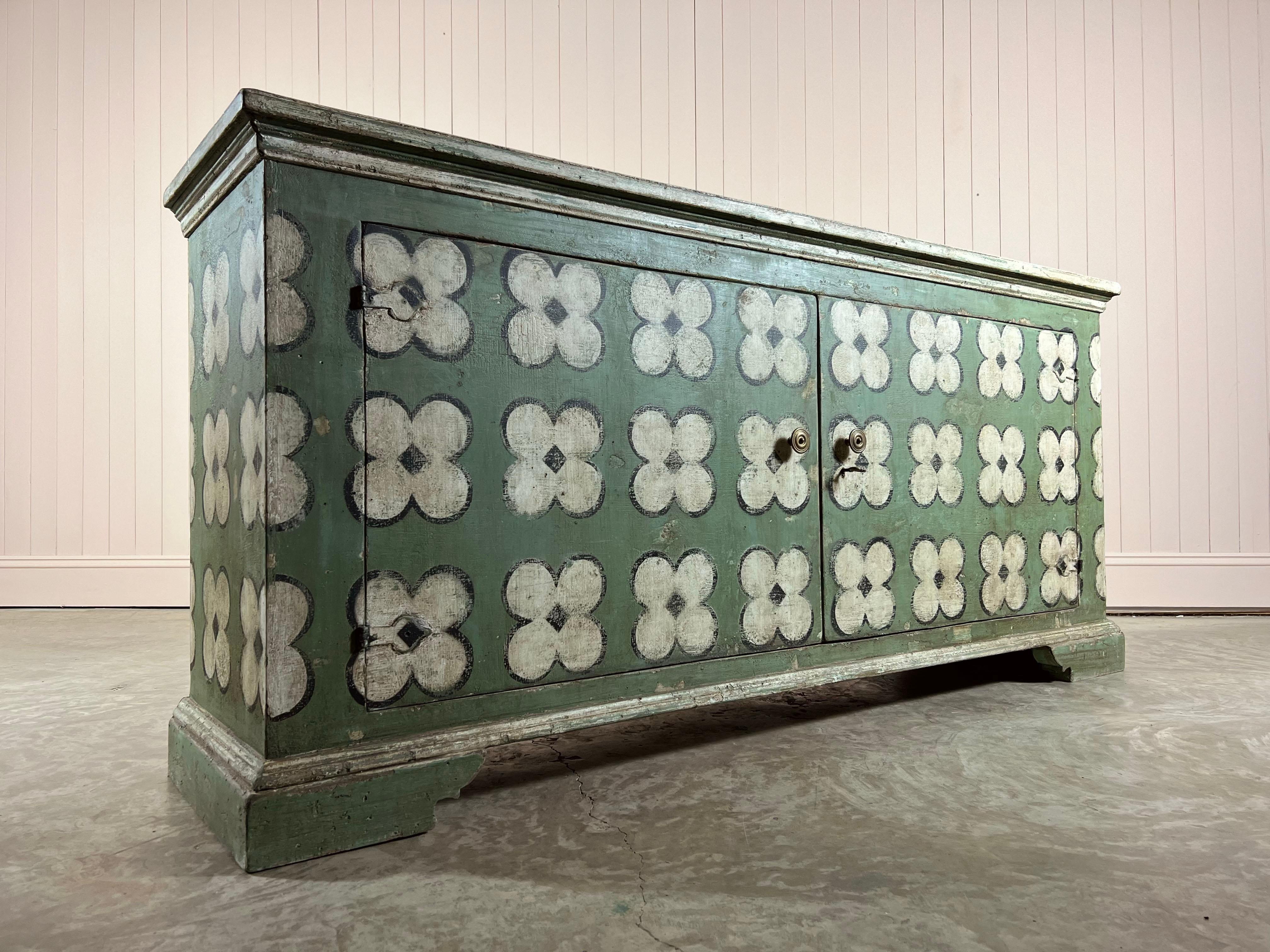 This is a painted sideboard with 'clover' design, that we commissioned from our excellent contacts in Italy and is made from reclaimed pine.

Newly made using these lovely gnarly 18th century boards which have loads of character and lend themselves