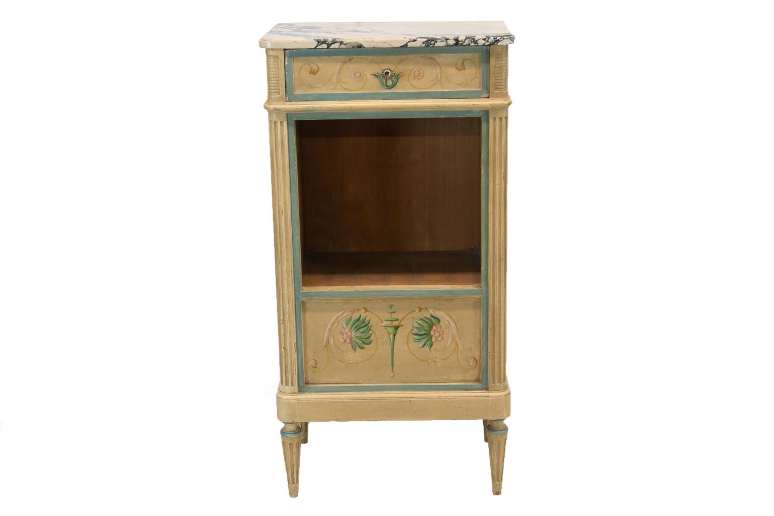 Painted Italianesque cabinet has the original marble with a shaped top edge and is painted with delicate floral arabesques. The corners are fluted, and end in fluted feet.
 
