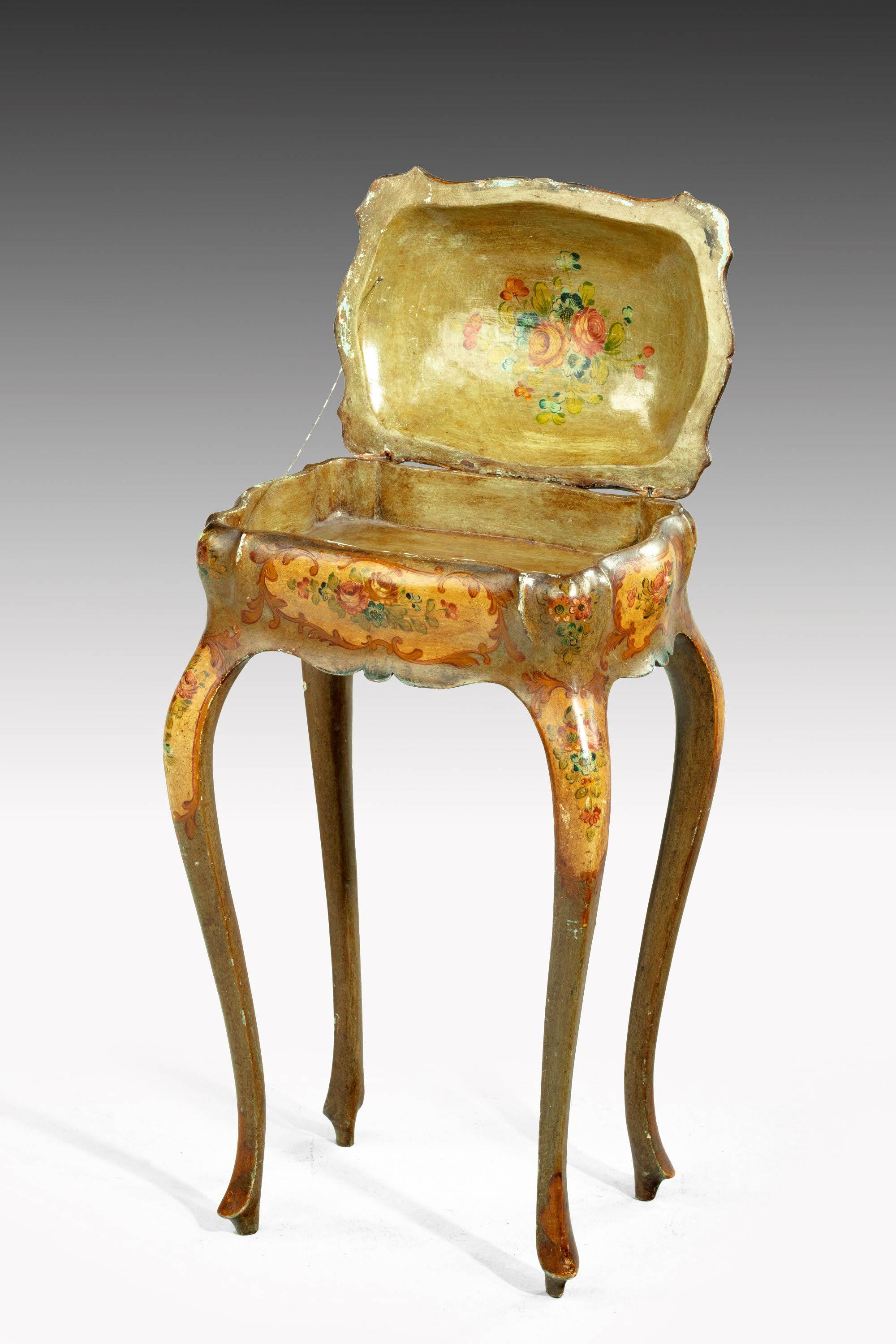 A painted ladies sewing table of exaggerated Bombay form.