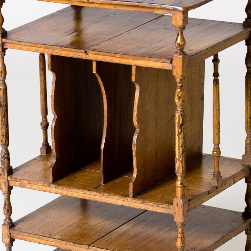Painted wooden magazine table from late 19th-century England. A charming way to store magazines, periodicals, and other such paper ephemera, this Victorian magazine table provides ample opportunities for both vertical and horizontal storage. With