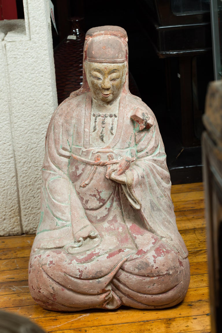 A Ming dynasty period 15th or 16th century painted stone sculpture of the Bodhisattva of Compassion Guanyin in a seated position. Created in China during the Ming dynasty, this marble statue features Guanyin, the Bodhisattva of Compassion, depicted
