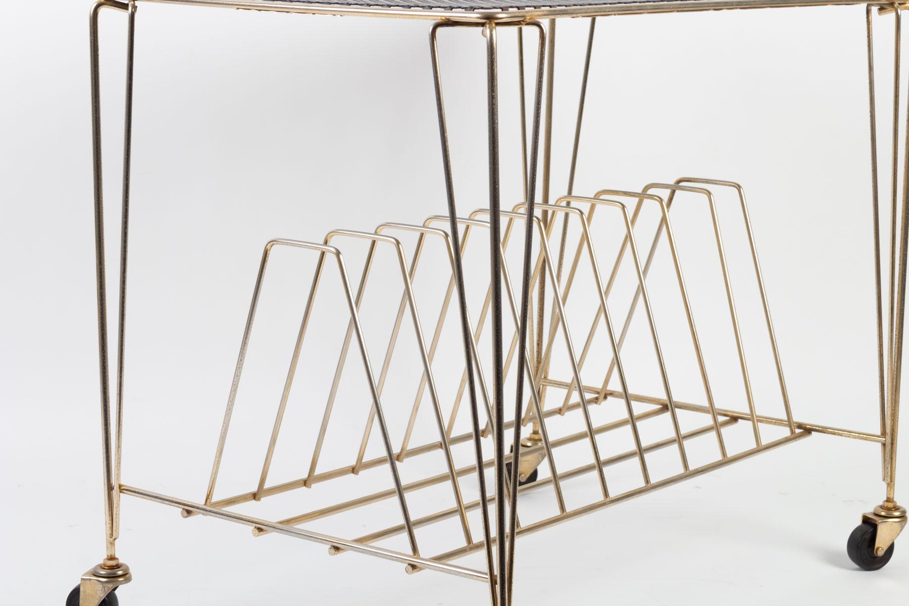 Painted metal and brass side table, 1960s, on casters.

Measures: H 51 cm, W 59 cm, D 40 cm.