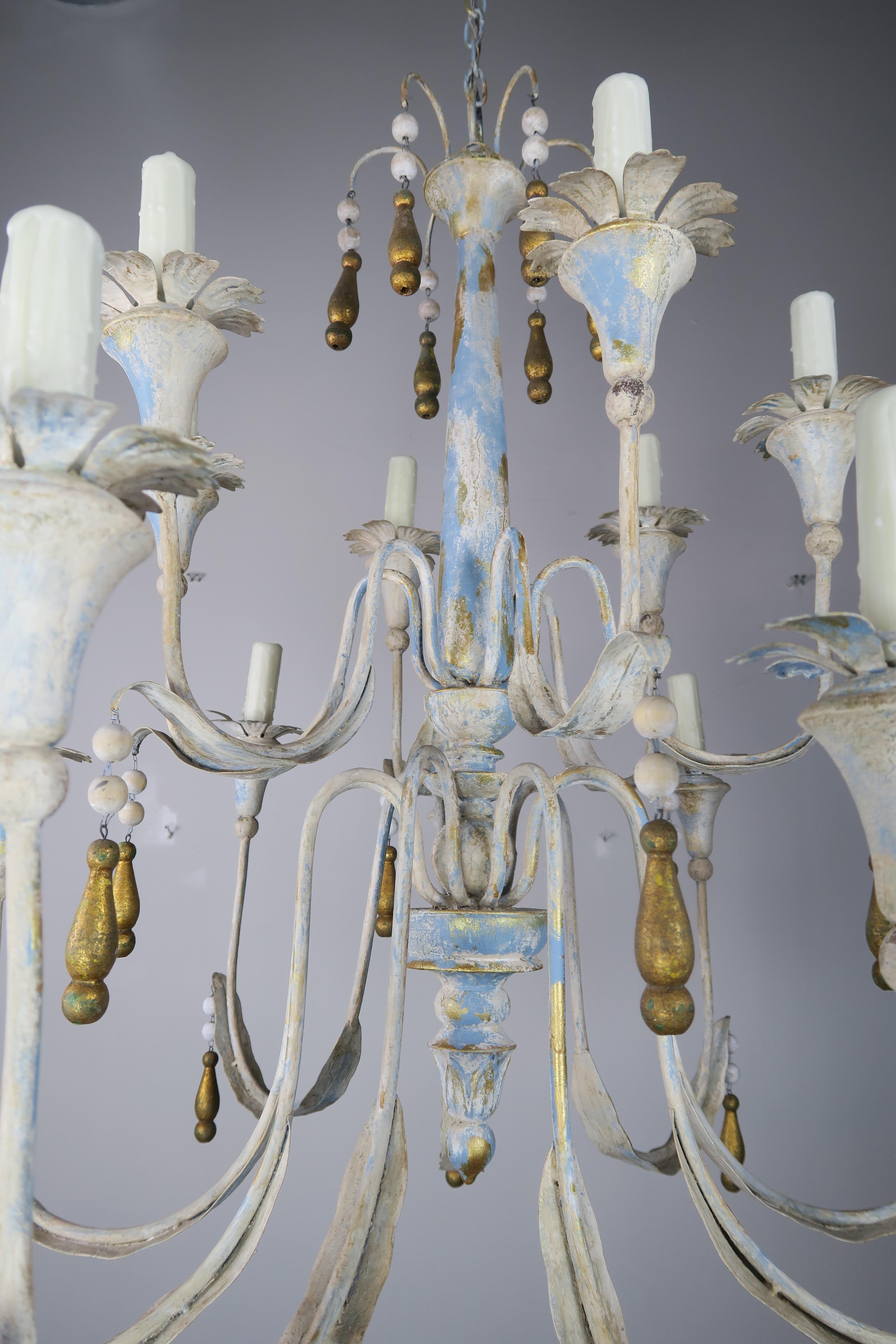 2-tier (15) light Italian painted metal chandelier with metallic gold wood tassels hanging throughout. The chandelier is newly rewired with cream colored drip wax candle covers. Includes chain and canopy.