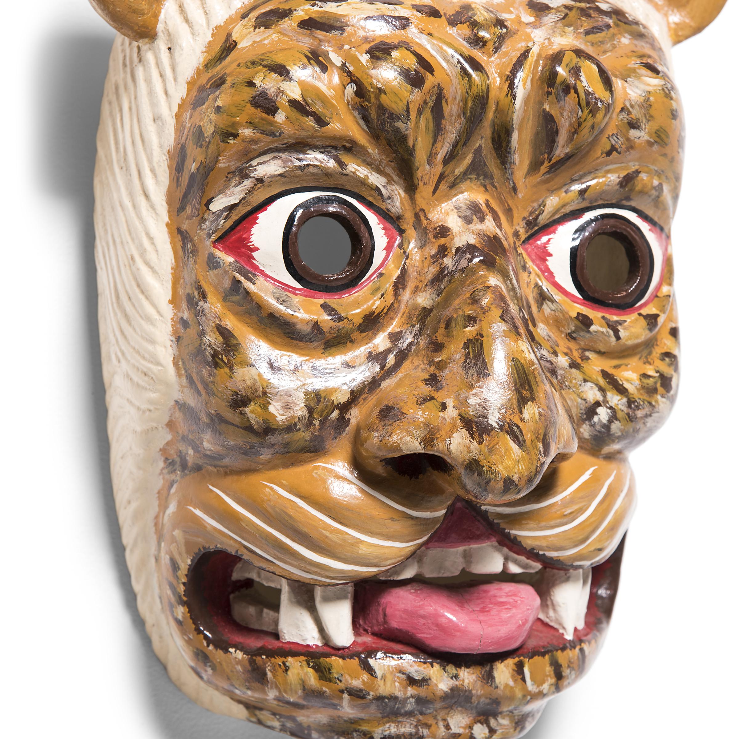 The Jaguar Mask is an essential component of traditional Mexican dance and ritual, symbolizing power and ferocity. This particular mask hails from the state of Guerrero, Mexico known for its rich cultural heritage and striking artistry. Guerrero has