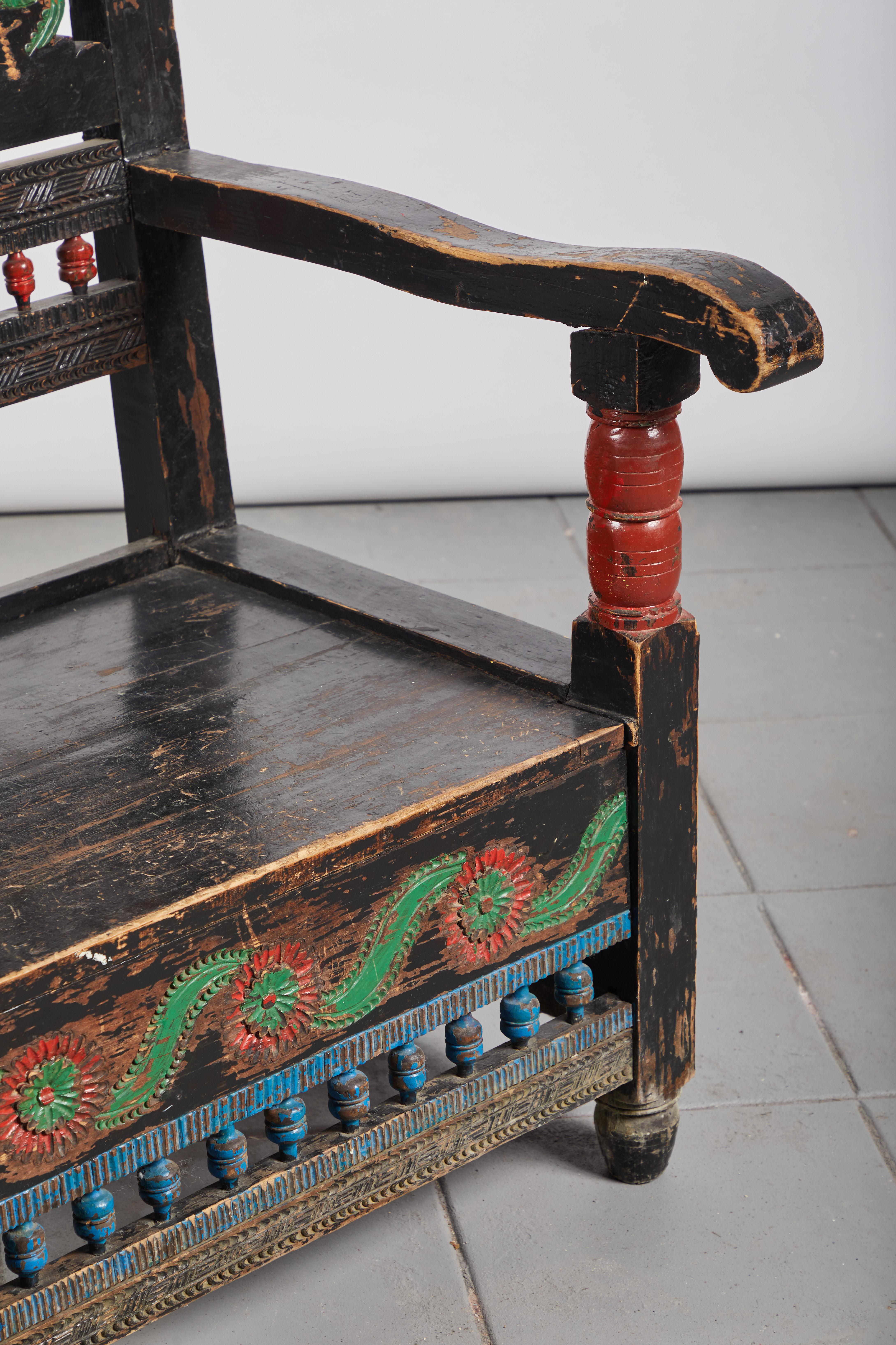 Beautiful Mexican hand painted and colorful armchair from the state of Michoacan. The chair is beautifully hand carved with floral and spindle details.