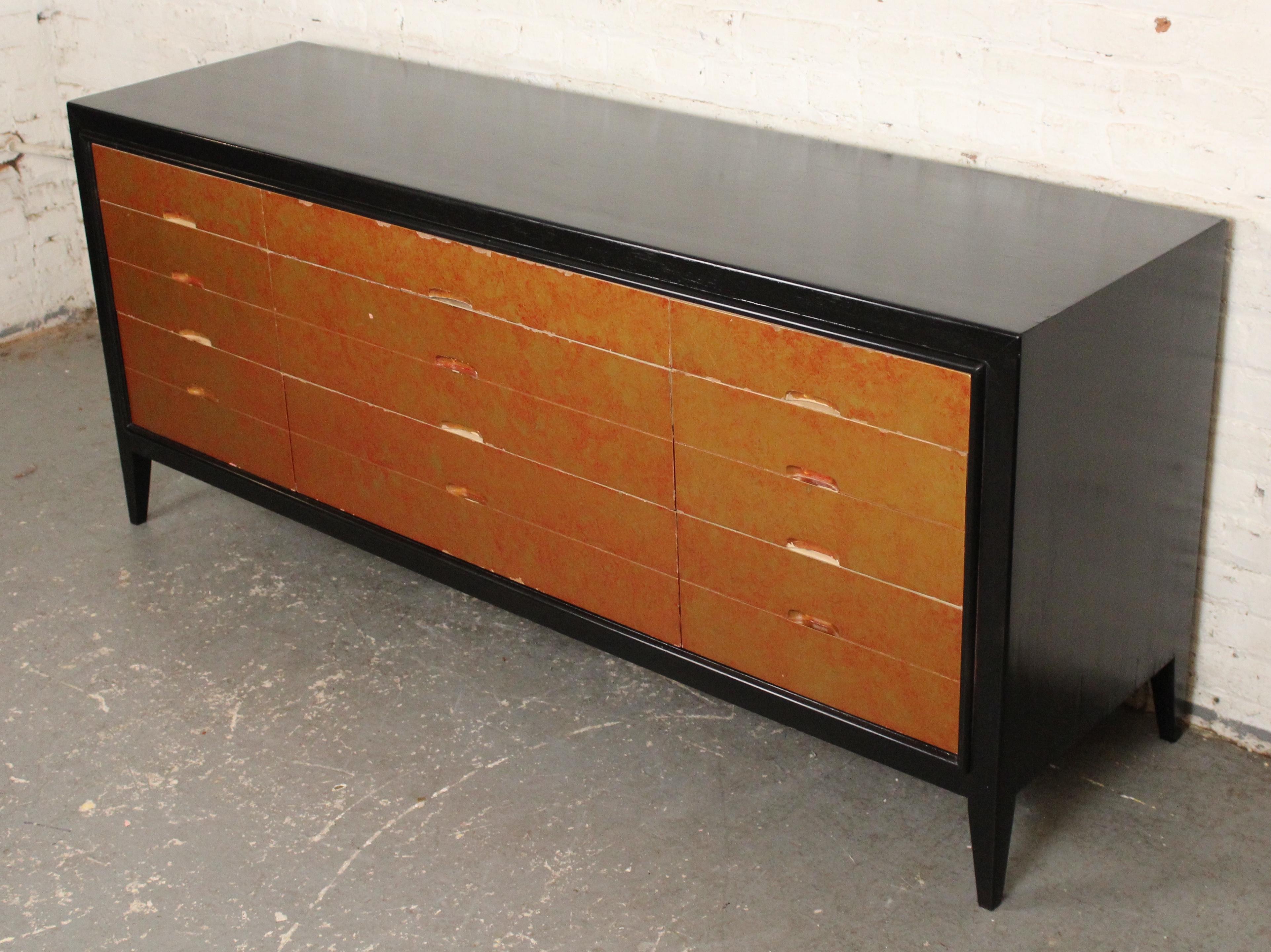Long nine drawer dresser with painted tortoise shell pattern front and black top and sides. This dresser pops with a bright yellow and red front, which is accented by the black frame.
Please confirm location NY or NJ