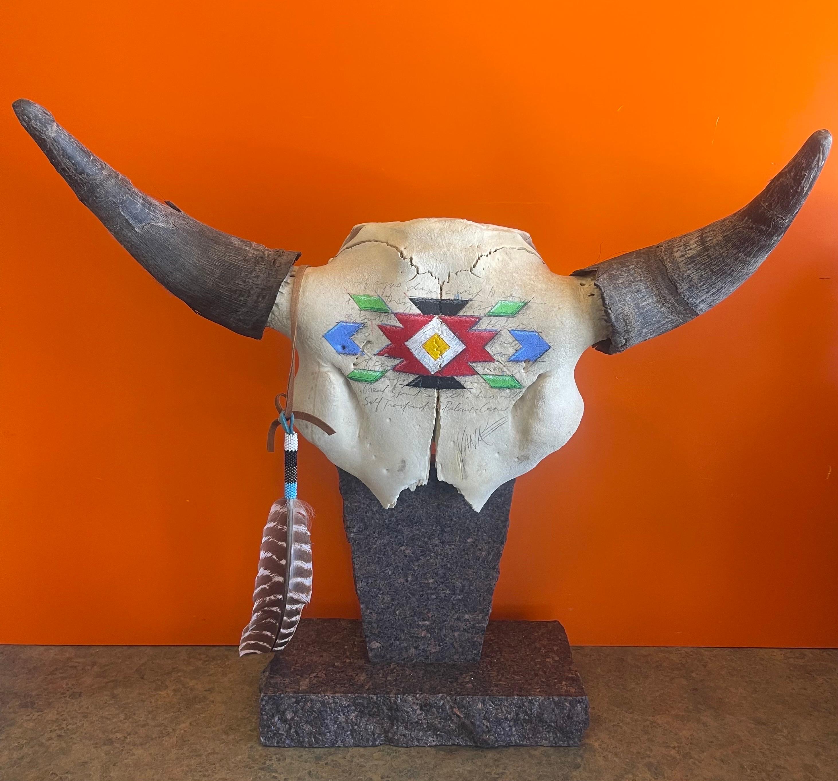 A really cool and unique painted north American steer skull with horns sculpture on granite base by Tim Yanke, circa 2000s. This piece has a great look and is hand painted across the forehead of the scull; it is signed by the artist. The sculpture