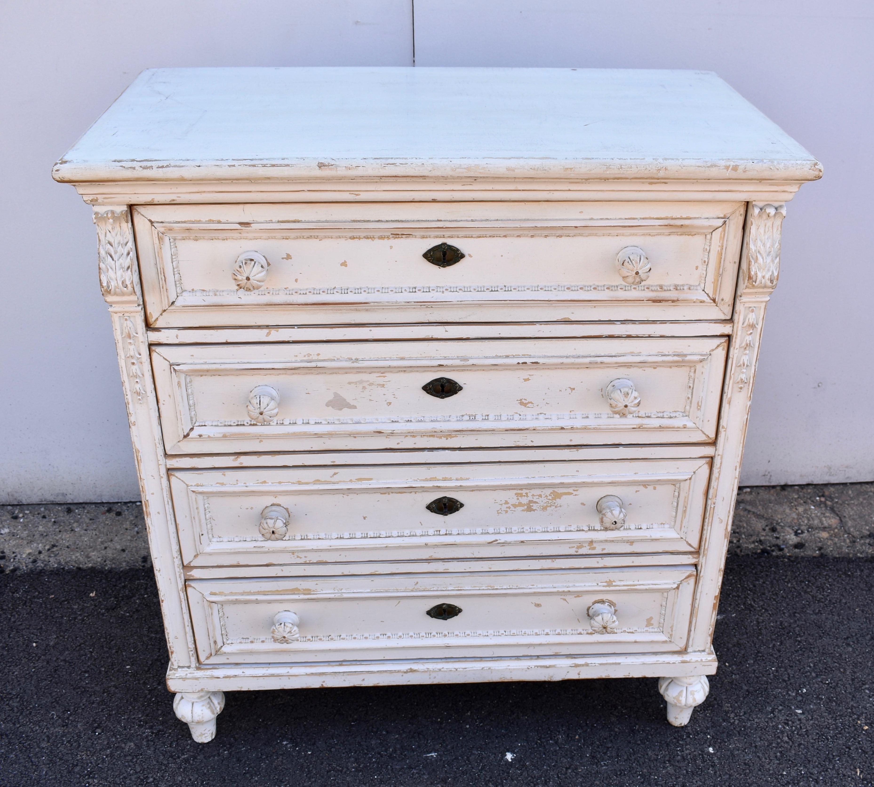 What an extraordinary chest of drawers! The top is plain with a bullnose edge and the sides are nicely paneled. The front corners of the case are boldly reeded and toward the top a sprig of lily of the valley is delicately carved inside the reed.