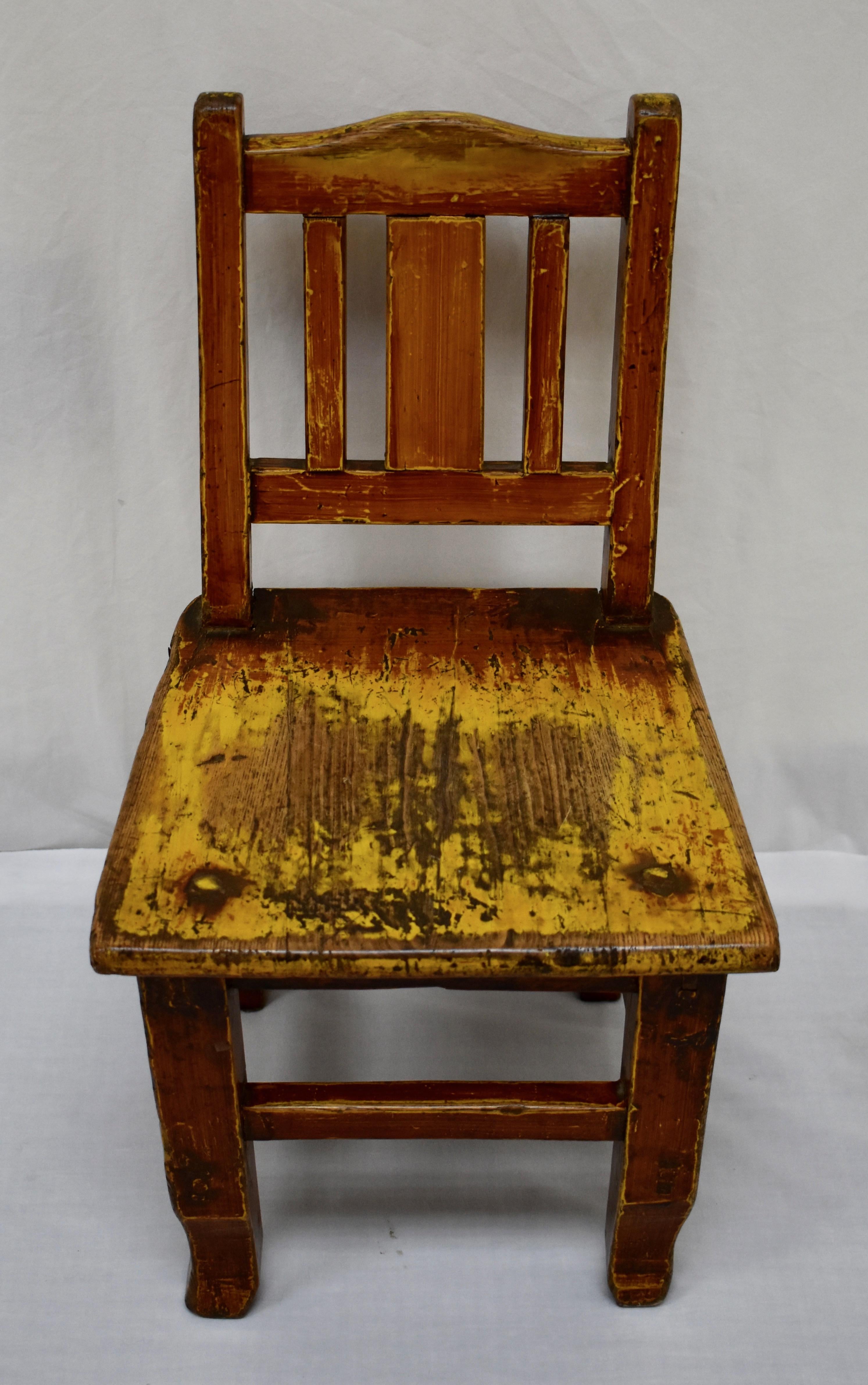 This is an outstanding central European plank-seat child’s chair, beautifully built from oak with pegged, through tenon and stretcher construction. A stylized grain paint has been applied over and has worn through to the original mustard. This, in