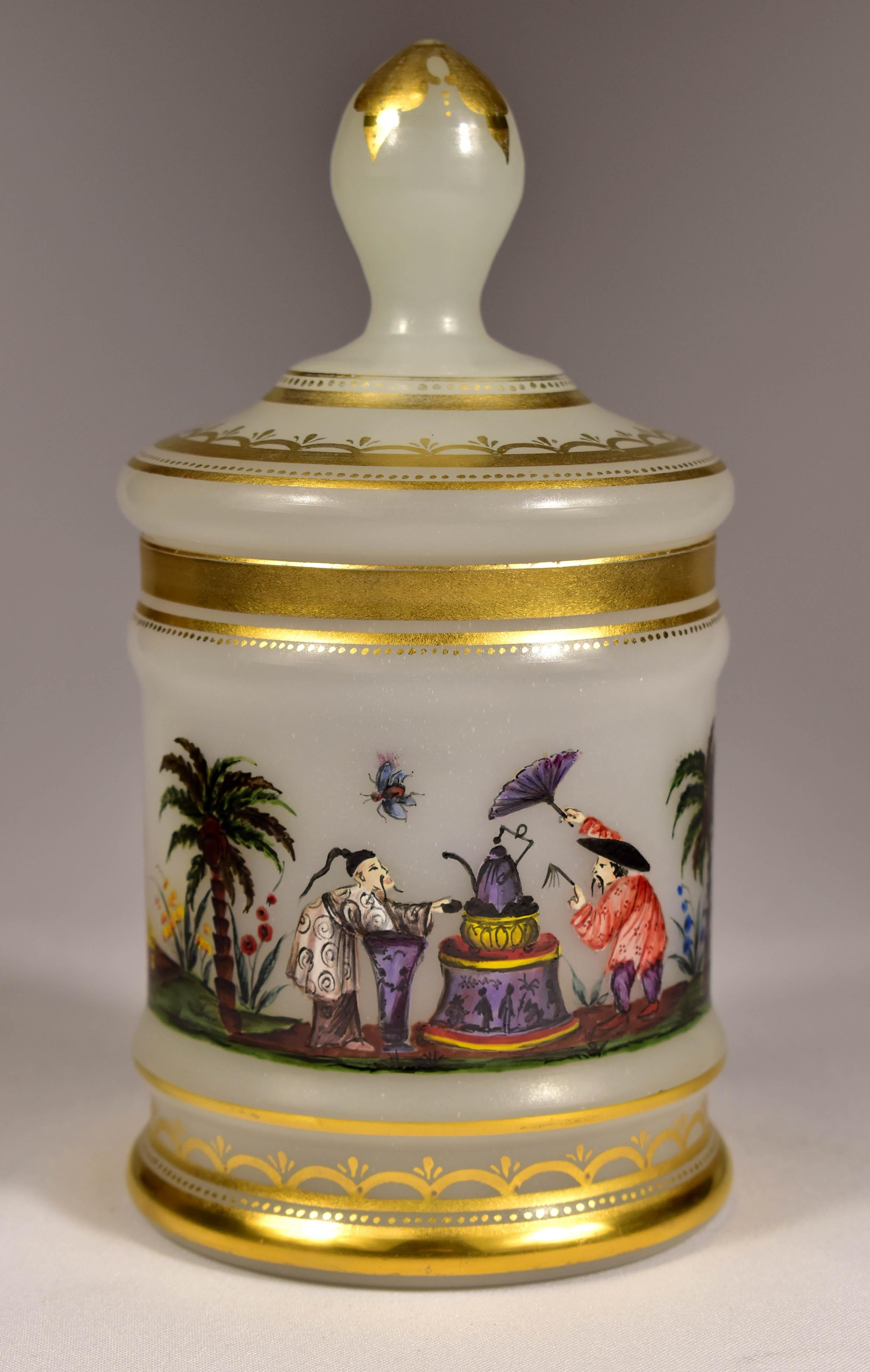 Box made of white opal glass painted with a chinoiserie motif, A motif depicting the preparation and drinking of tea, This motif was very popular in the 19th century. So the box was probably used to store tea. This is probably a work from the first