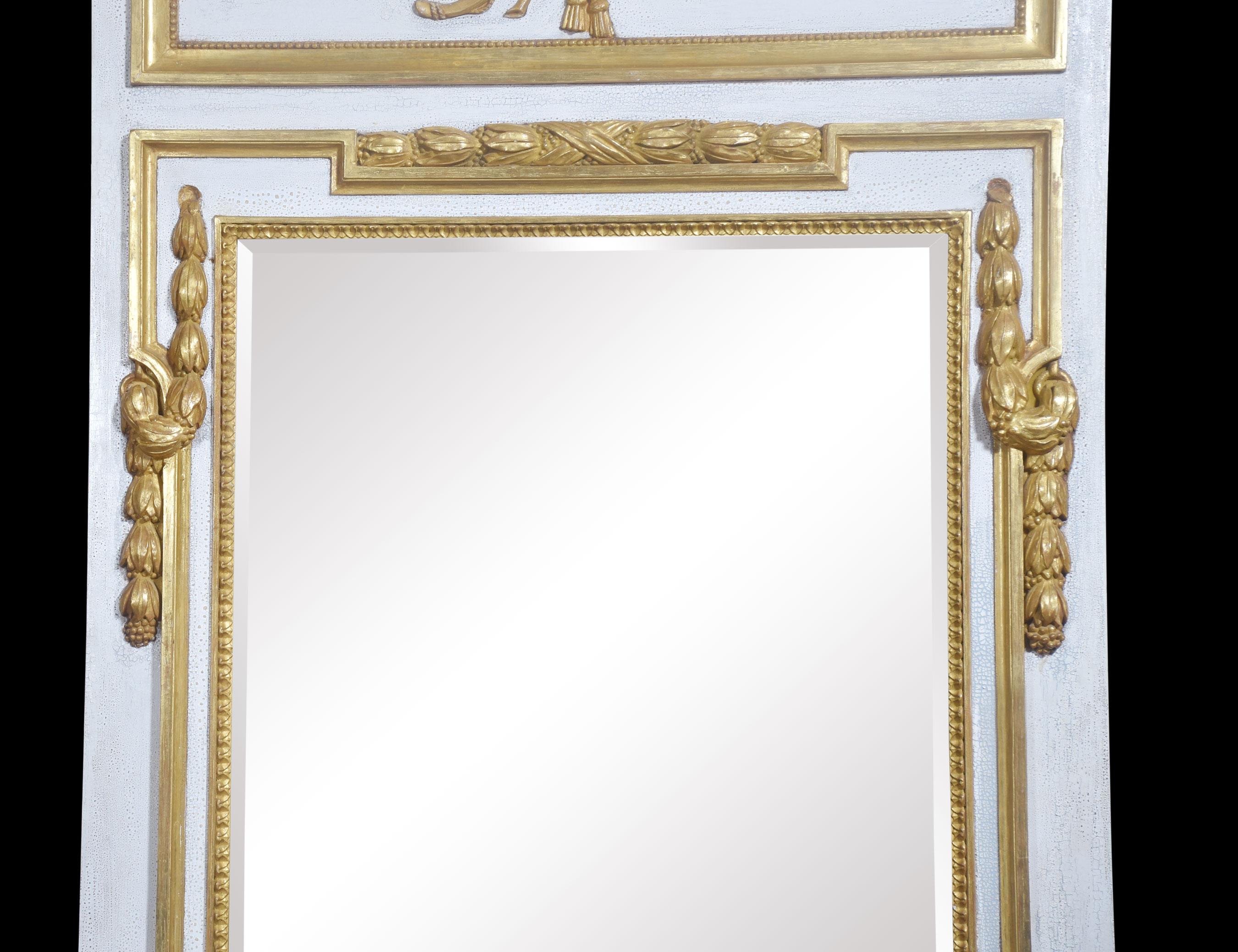 White painted wall mirror having carved flaming torch and quiver giltwood decoration, above the original bevelled mirror plate enclosed in gilt-wood border.
Dimensions
Height 79 Inches
Width 43 Inches
Depth 3.5 Inches