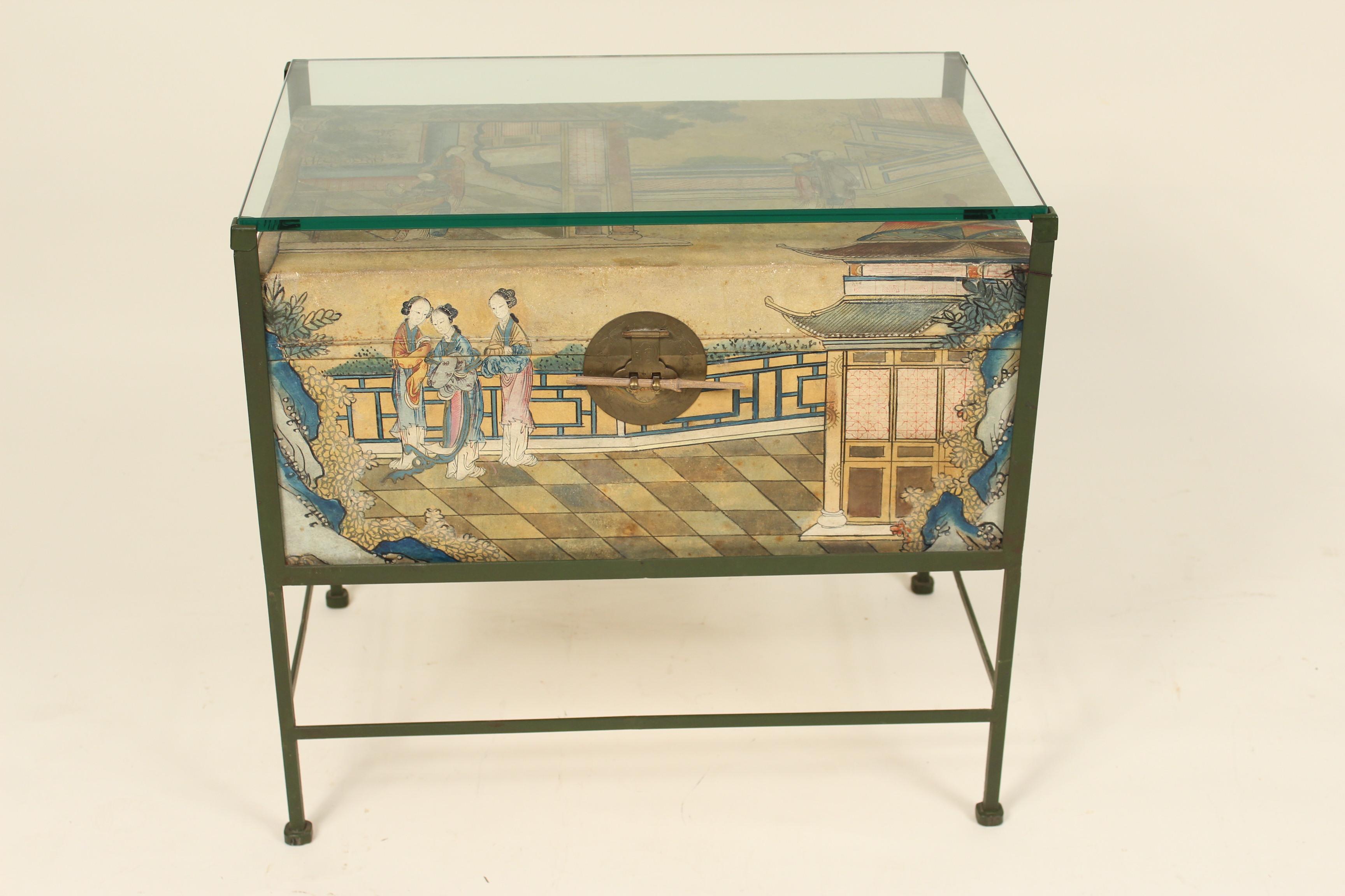 Chinese painted pigskin trunk mounted on an iron stand with glass top, to be used as an end table or coffee table,. The pigskin trunk was made circa 1920s, the iron stand and glass top are late 20th century.