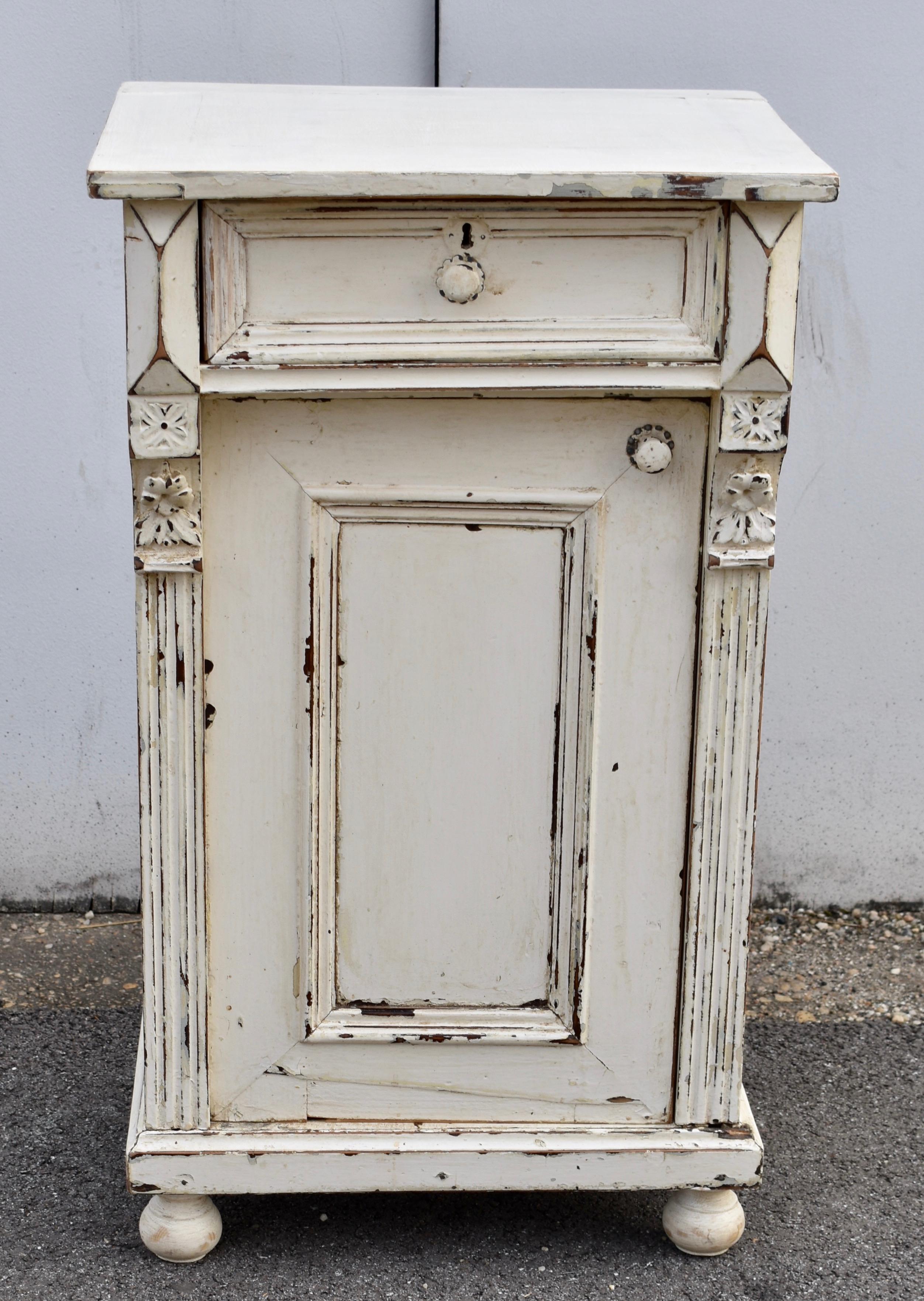 This nightstand has great character both in its construction and its finish.  The hand-cut dovetailed drawer stands a little proud of the rest of the case and its front is bordered by an ogee molding to suggest a panel.  Pyramid appliqués stand each