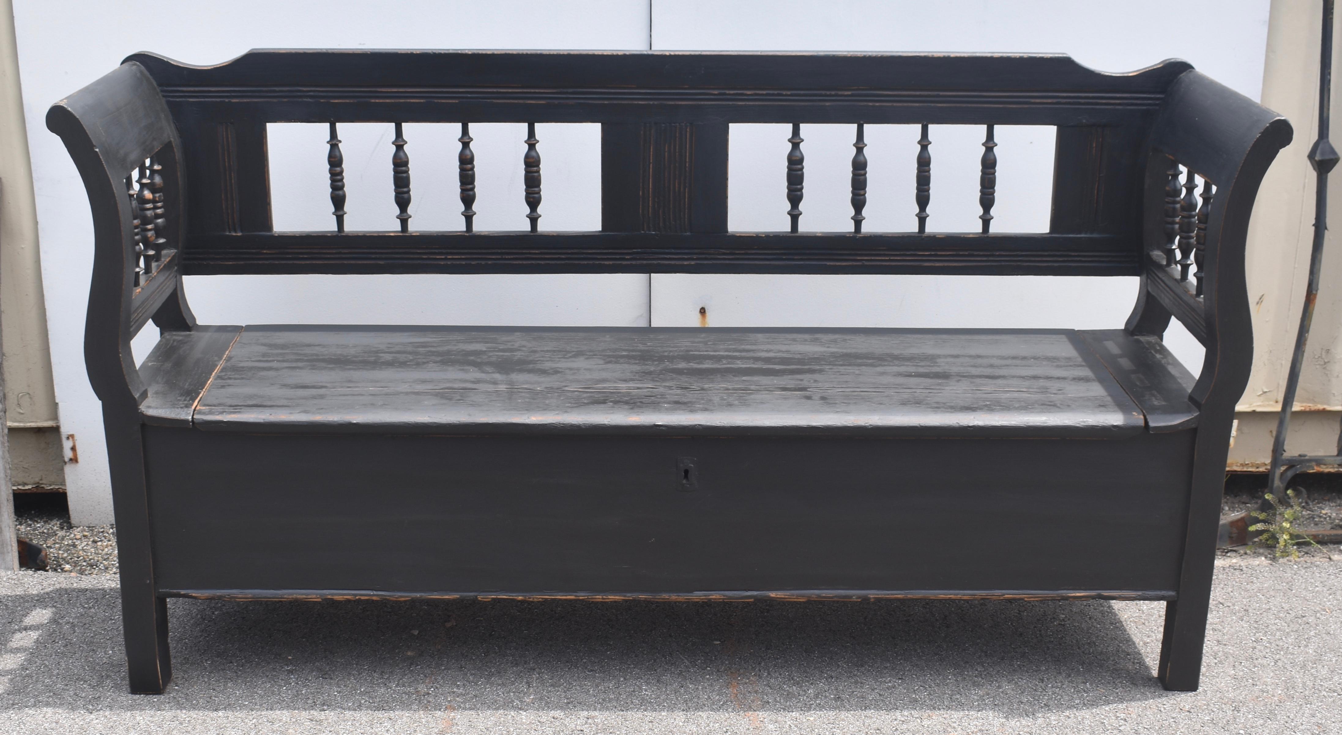 This Box Bench has a great form and has all the characteristics we look for in a Central European Storage Bench.  For most of its length the top rail is flat, only following a curve where it meets the scrolled armrest.  The straight bottom rail,