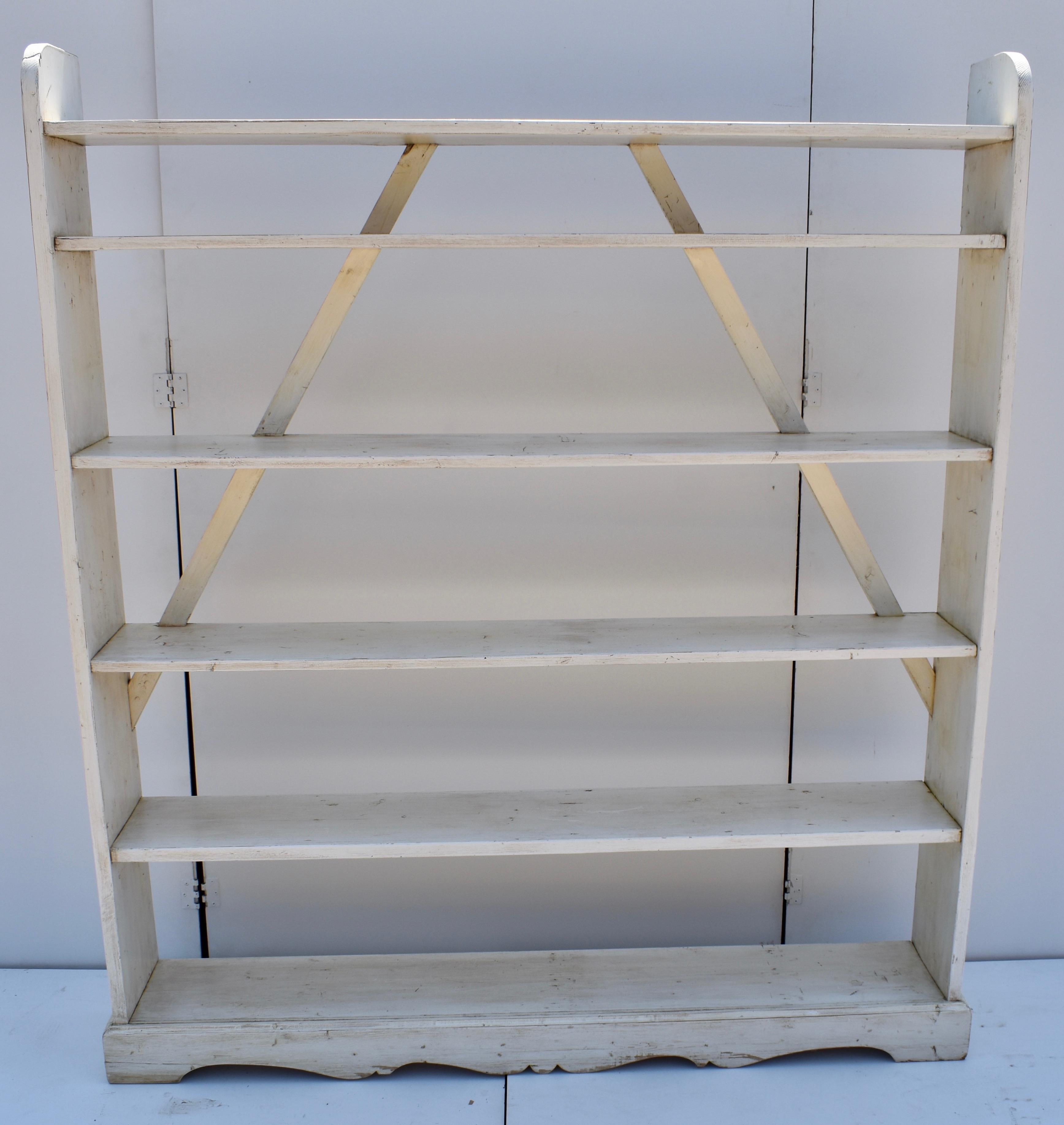 This is a simple but very attractive unit of six shelves, standing on nicely formed, scalloped bracket feet. It is immensely strong. The shelves are dovetail-mortised into the sides and the two rear diagonal braces are notched into the top four