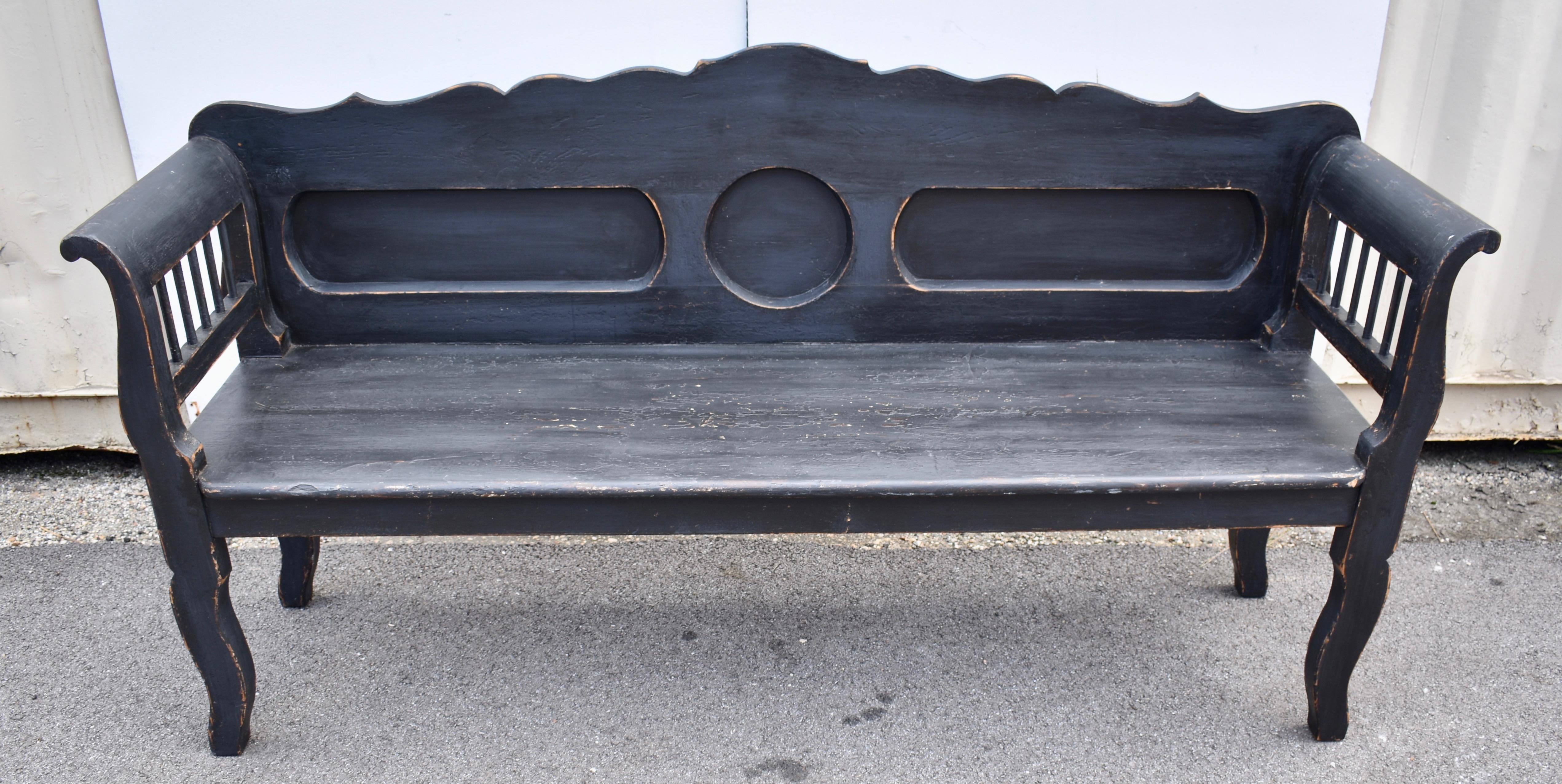 This classic Central European bench form is treated a little differently here.  The scalloped back rail ripples gently downward from the high point in the center.  The back is cut out to form a round faux panel in the middle with a racetrack oval on