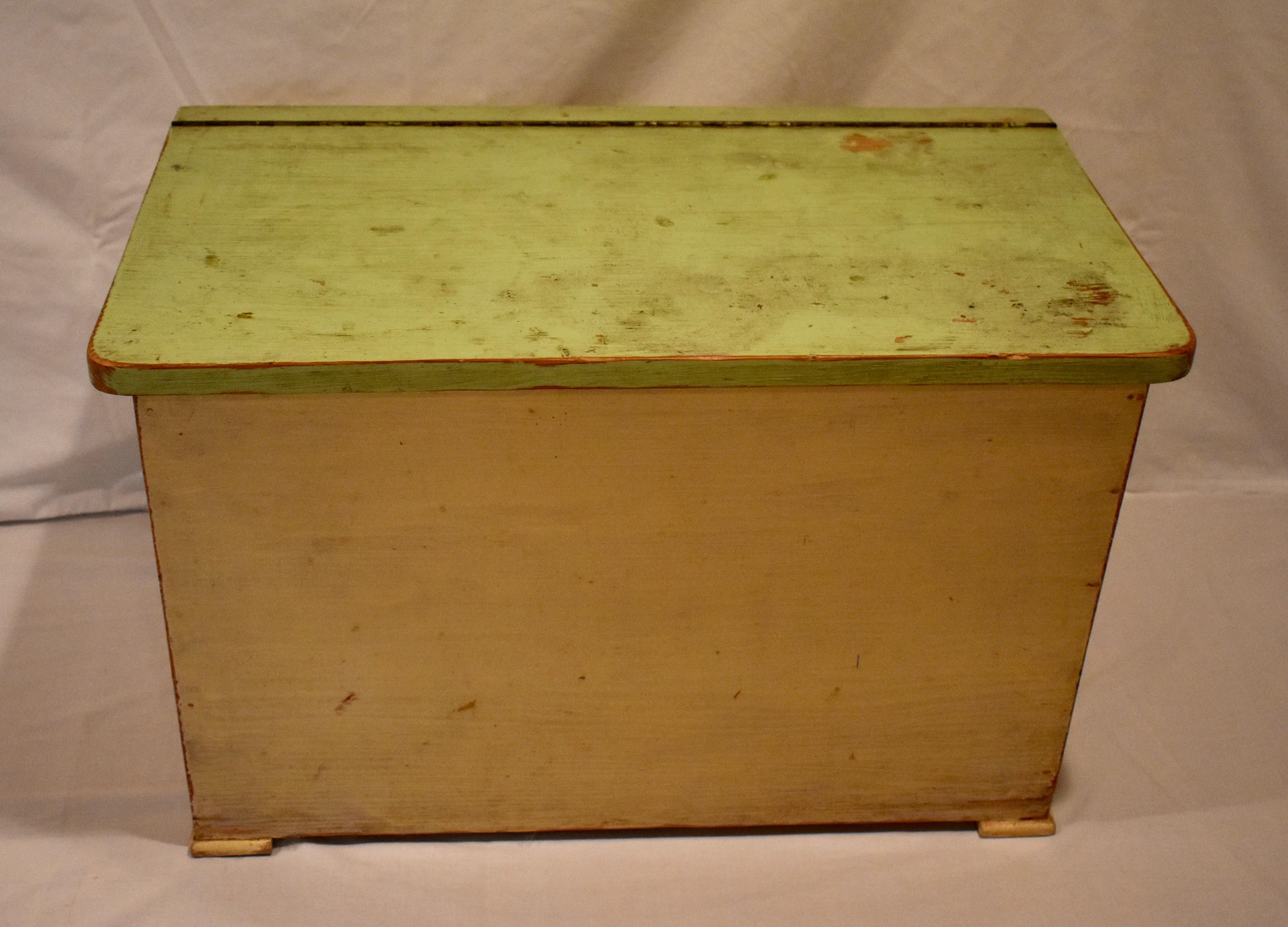 This sturdy little mortised and tenoned pine box has an attractive wedge shape, with a flat back and slightly sloping front. The lid, almost 1” thick, lifts on a brass continues hinge to access the deep storage well inside. This piece would be great