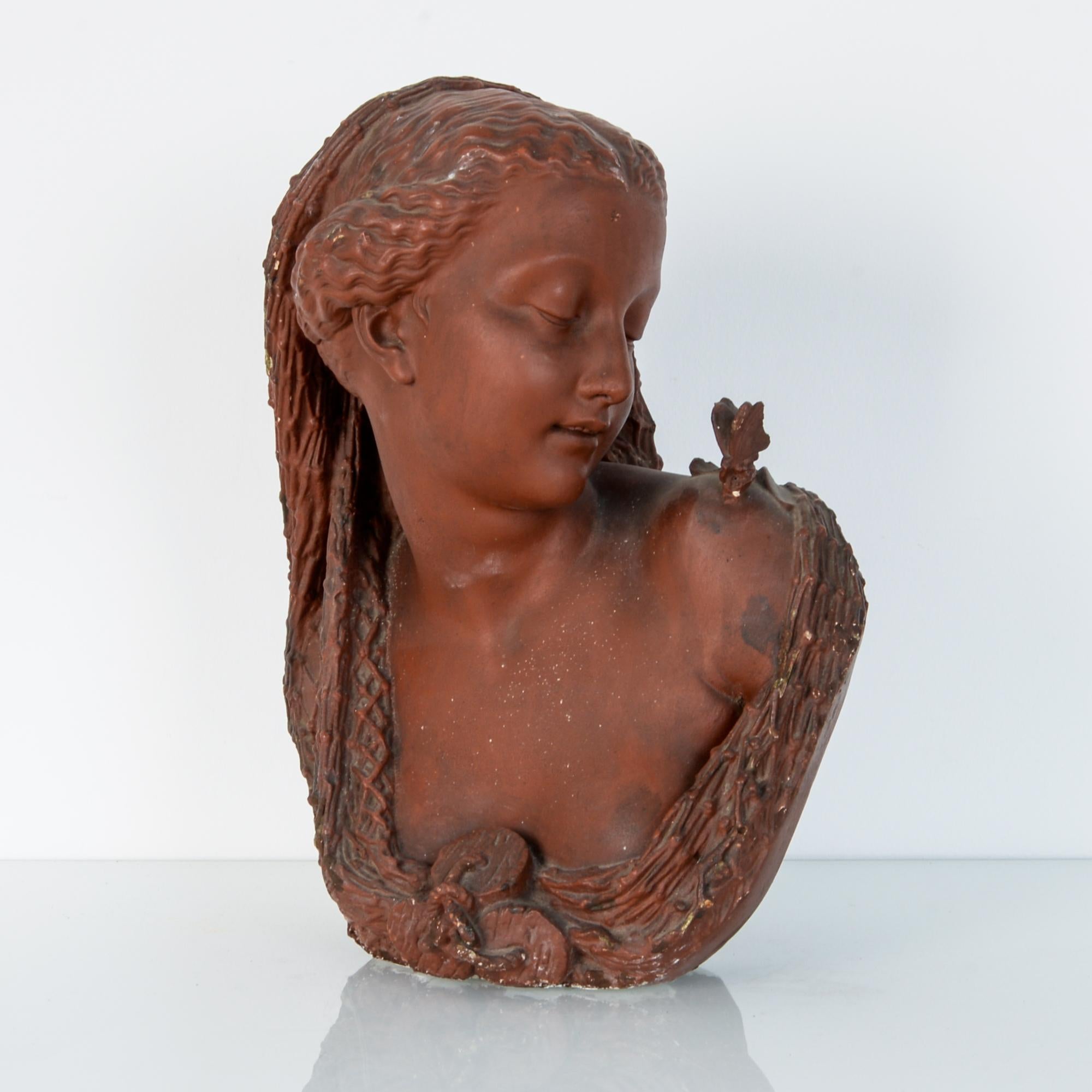 From France, late 19th century, this red painted plaster bust was originally placed in an architectural niche. Depicting a female figure in a pose of delight or curiosity, as intended, serves to enhance and lighten the interior decoration. With a