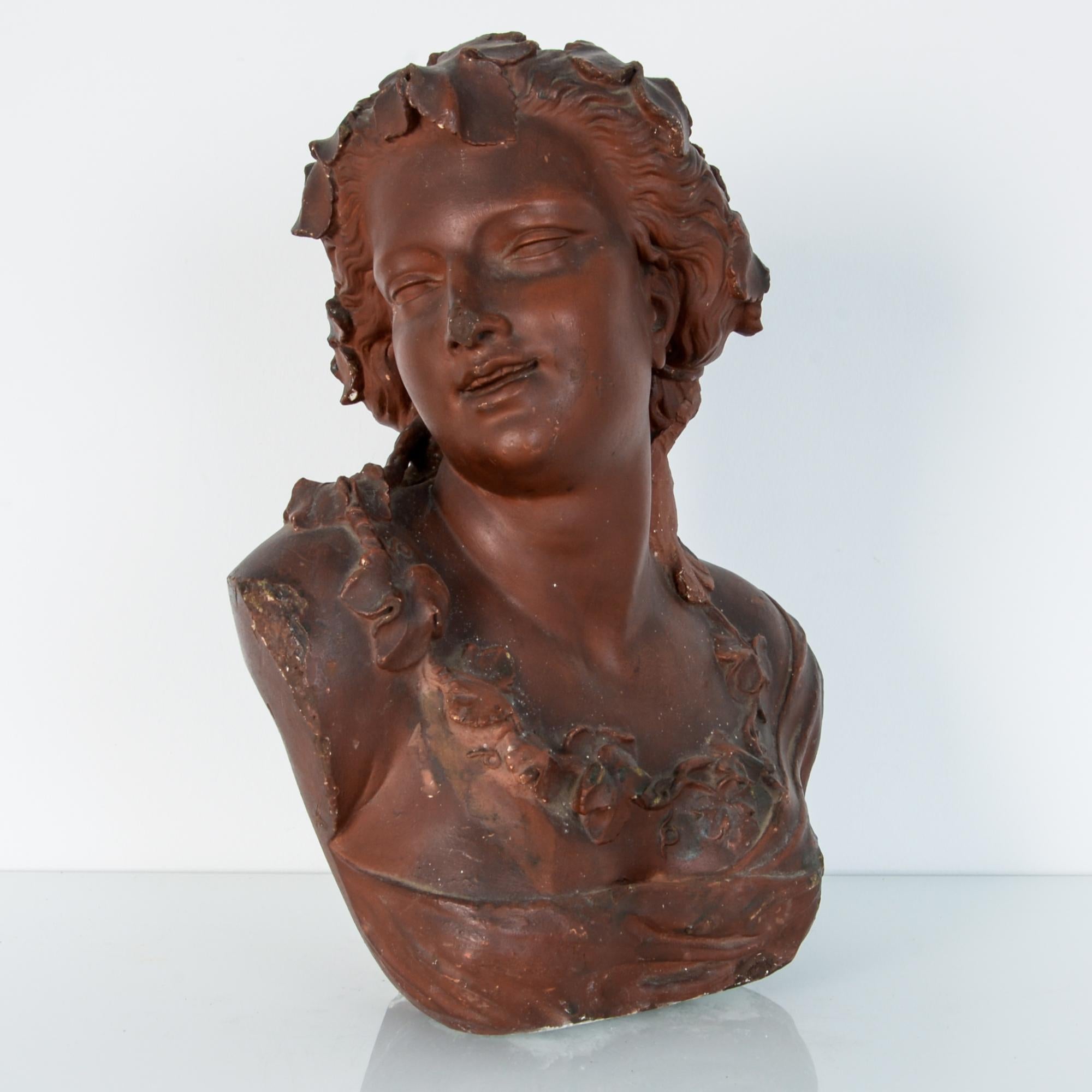 From France, late 19th century, this red painted plaster bust was originally placed in an architectural niche. Depicting a female figure in a pose of delight or curiosity, as intended, serves to enhance and lighten the interior decoration. With a