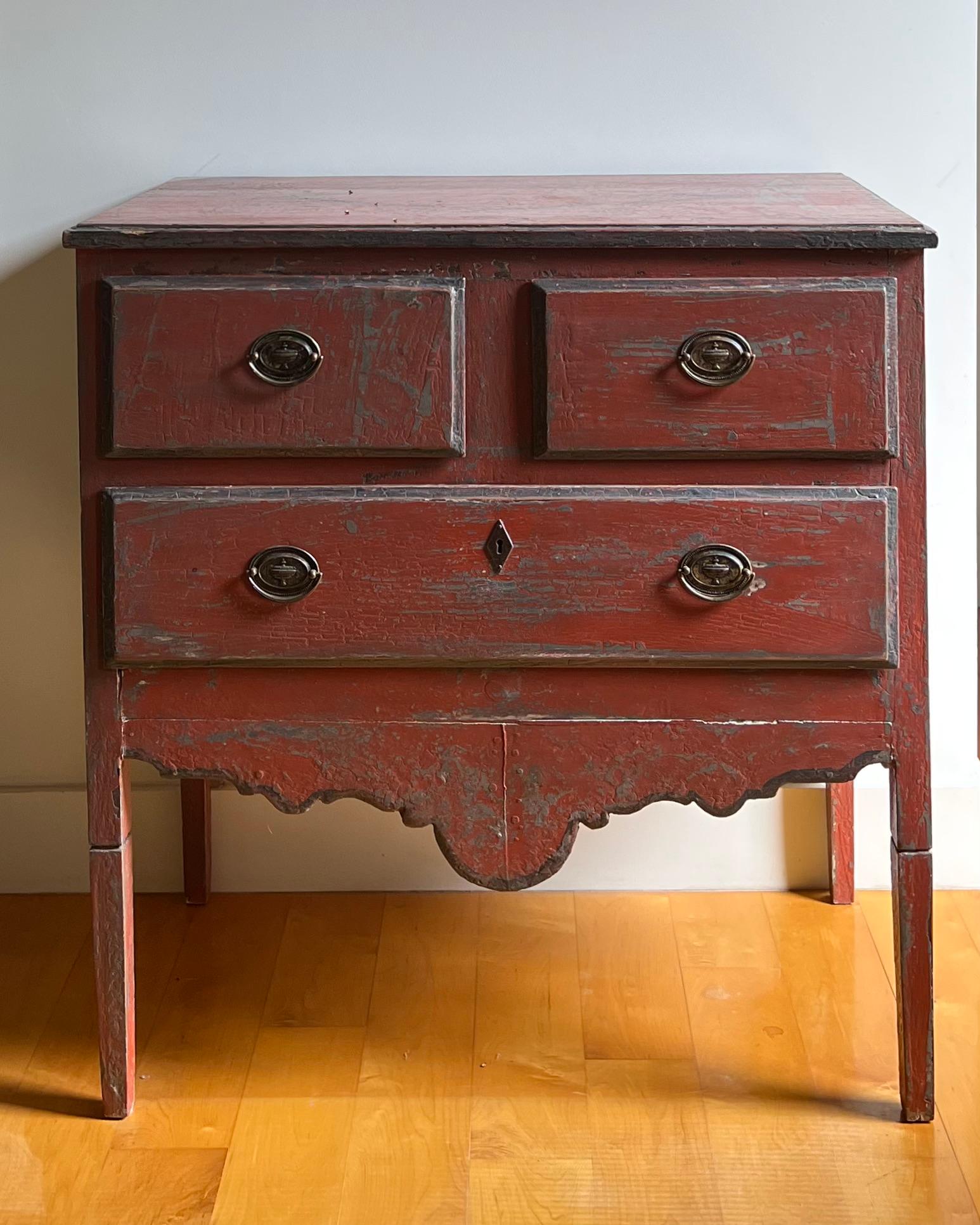 A charming painted rustic Portuguese commode with two small over one long drawer, whimsically shaped frieze and sides standing on long tapered legs
Portugal ca 1900's.