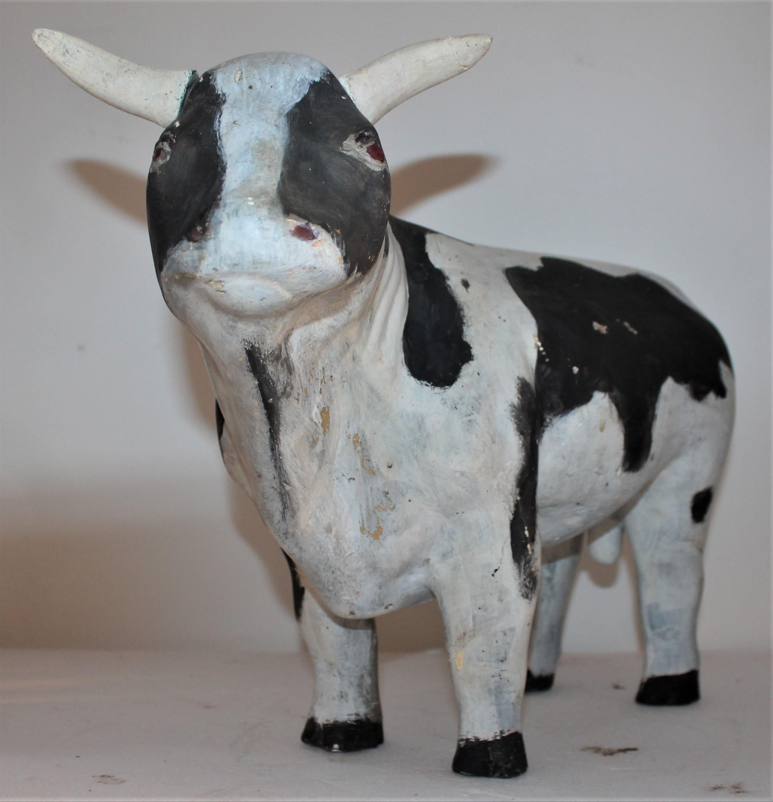 This folky handmade cow is in good condition with minor wear consistent from age and use.