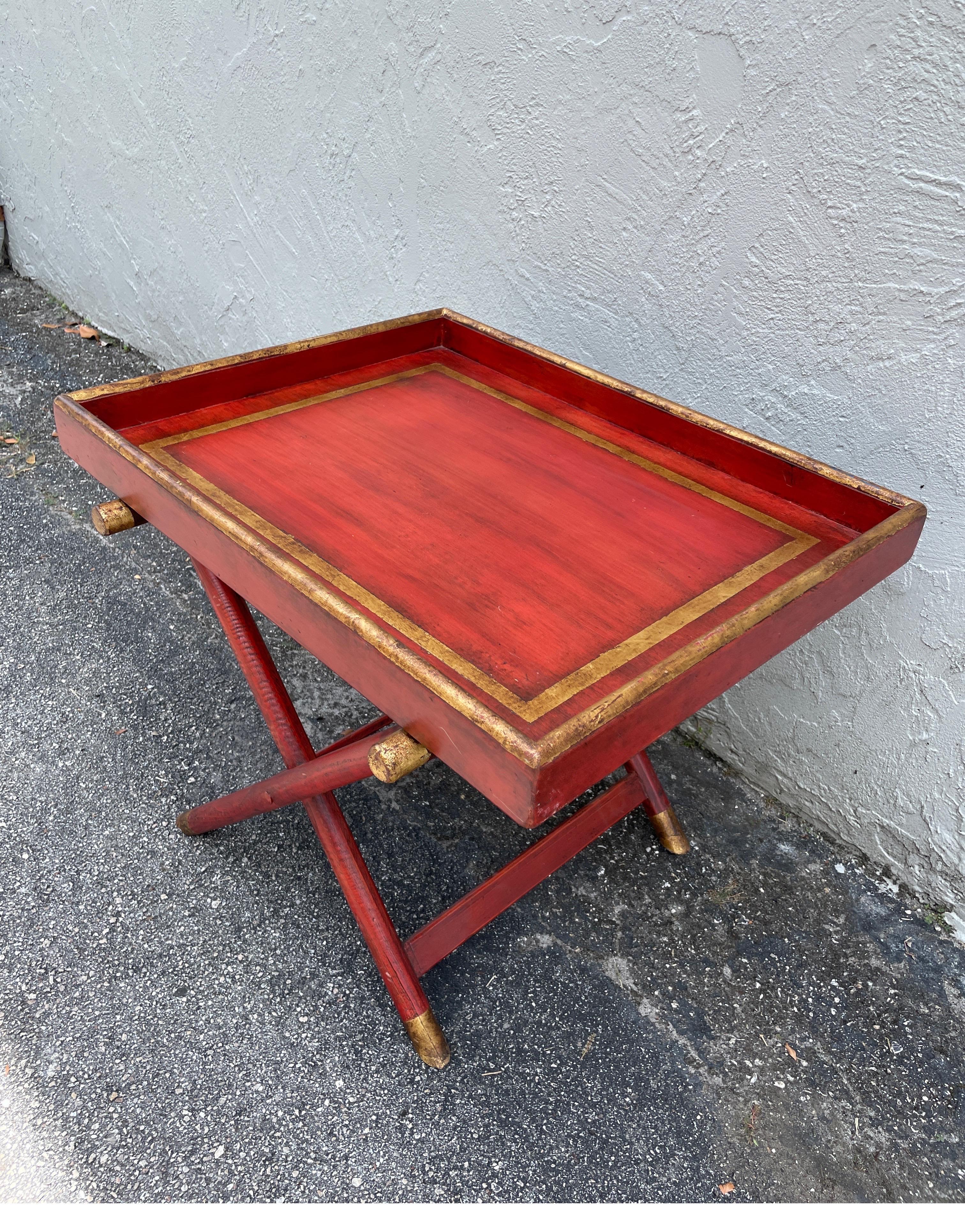 Hand painted tray top table in red with gold accents. Table does not collapse or detach. With X style base.