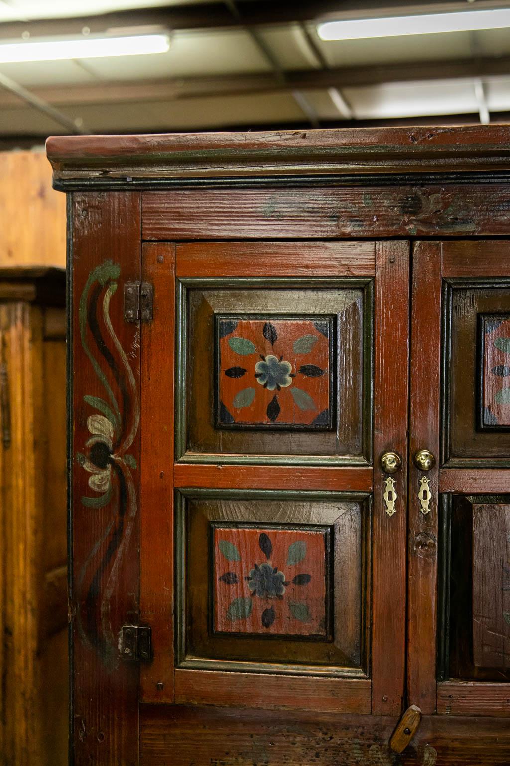 The inside top section of this cupboard has two fixed shelves. The lower section has a support structure for a shelf that could be made if desired. There is exposed peg construction throughout. The hinges are original and brass hardware is later.
